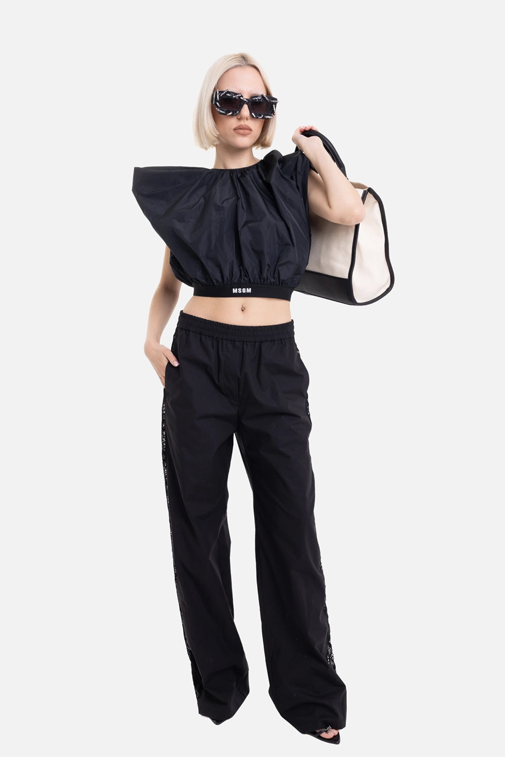 MSGM women's cotton pants in Black, on-model full-length view, wide legs with lace side inserts