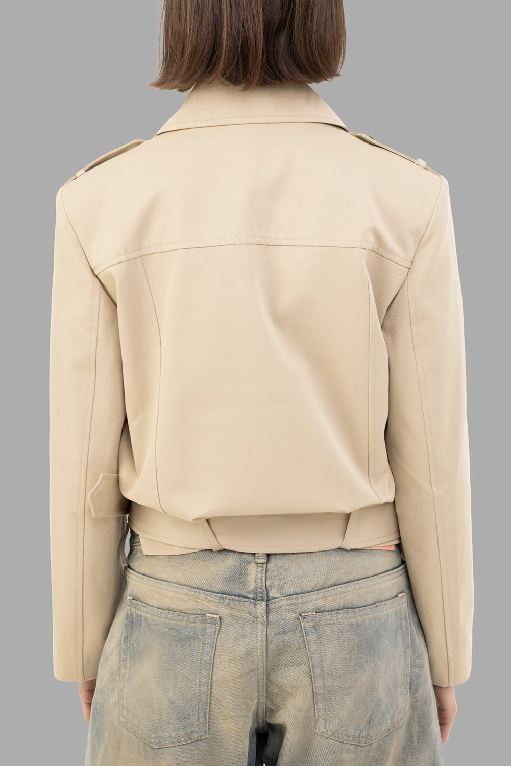 Anine Bing women's cropped trench jacket in Oatmeal, back view, epaulettes, back yoke and wraparound belt.