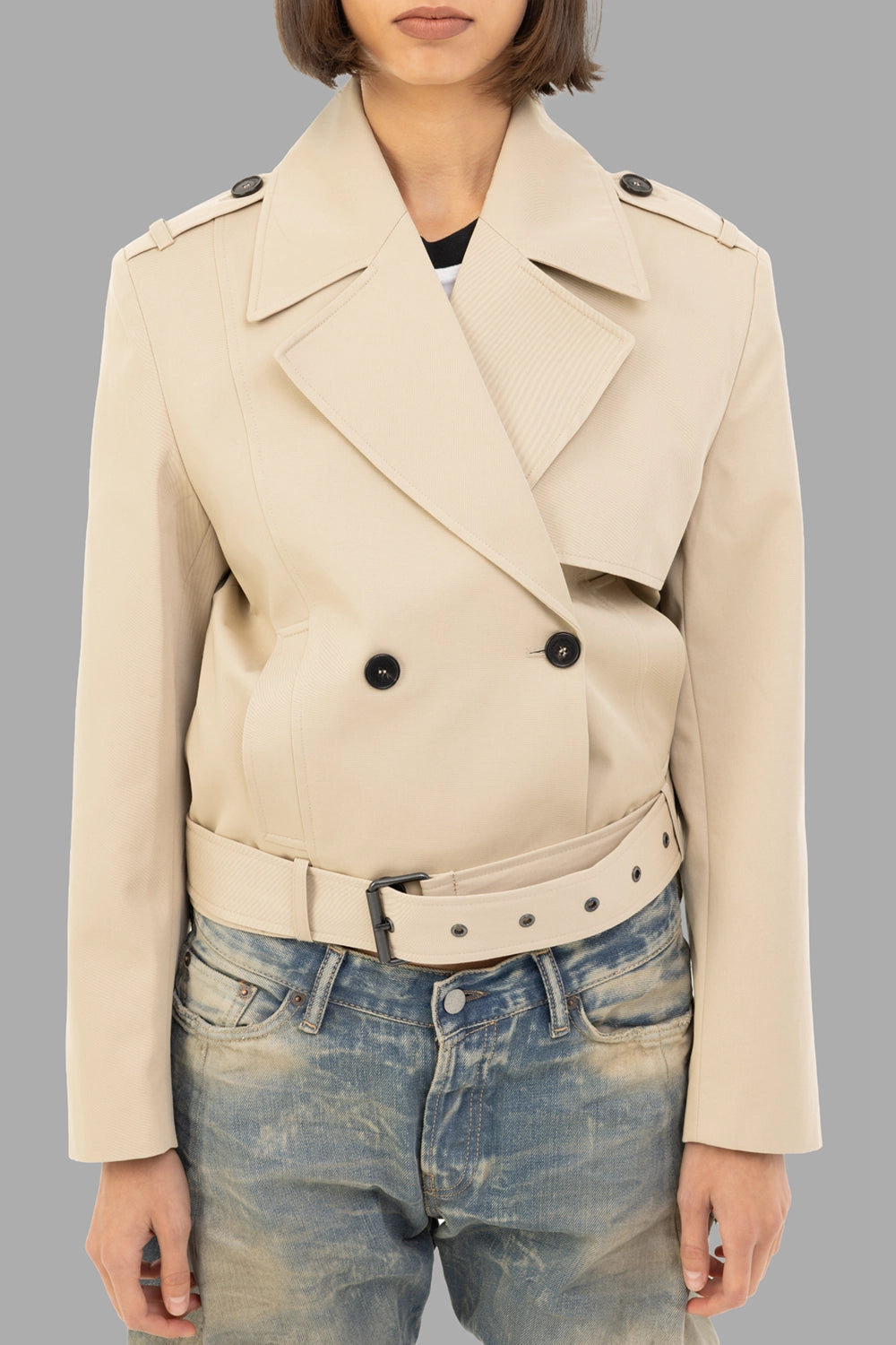 Anine Bing women's cropped trench jacket in Oatmeal, front view, epaulettes and double-breasted closure with belt.
