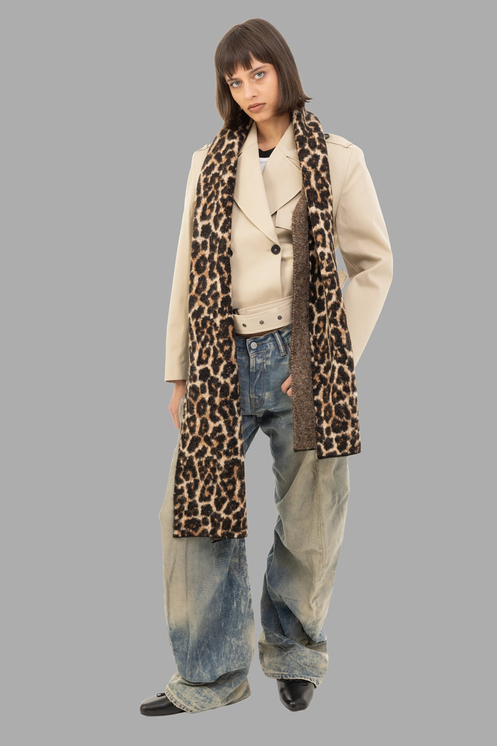 Anine Bing women's cropped trench jacket in Oatmeal, full-length on model, double-breasted front and waist belt.