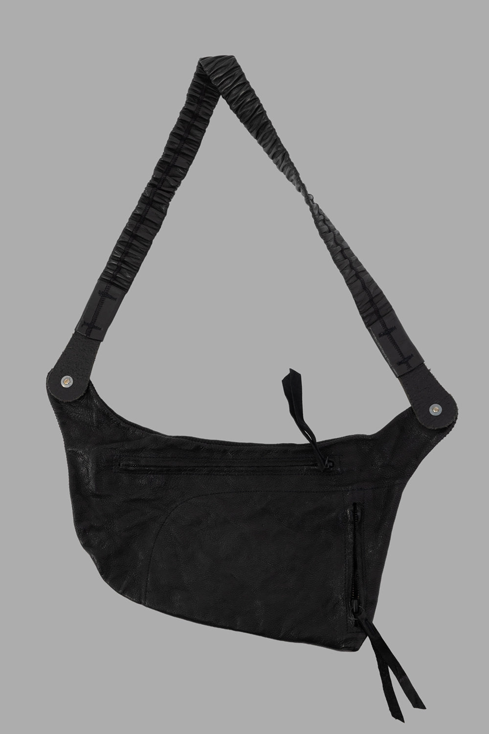 Isaac Sellam crossbody bag in black, back view, long top zip pocket and strap stitch details