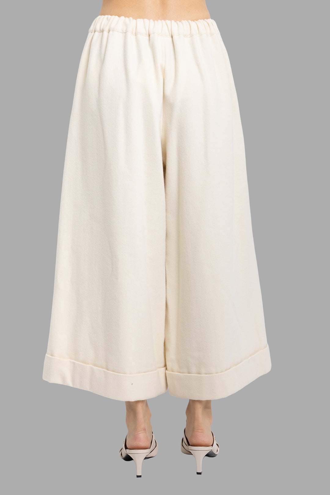 Comme des Garçons women's ivory wool culottes, back view, elasticated waistband and wide cropped legs with cuffed hem.