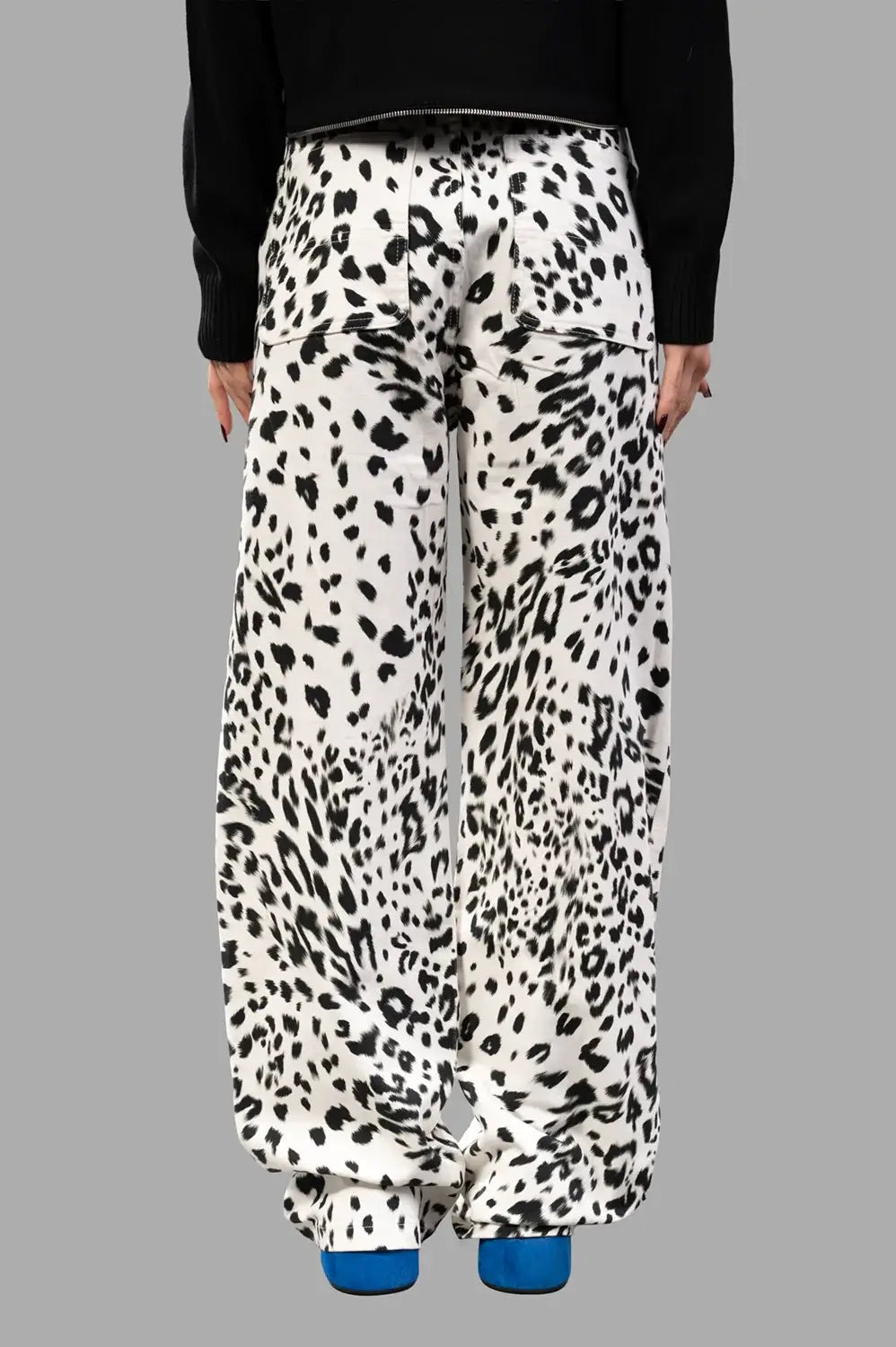 Back close-up showing patch pockets and wide leg drape in leopard print