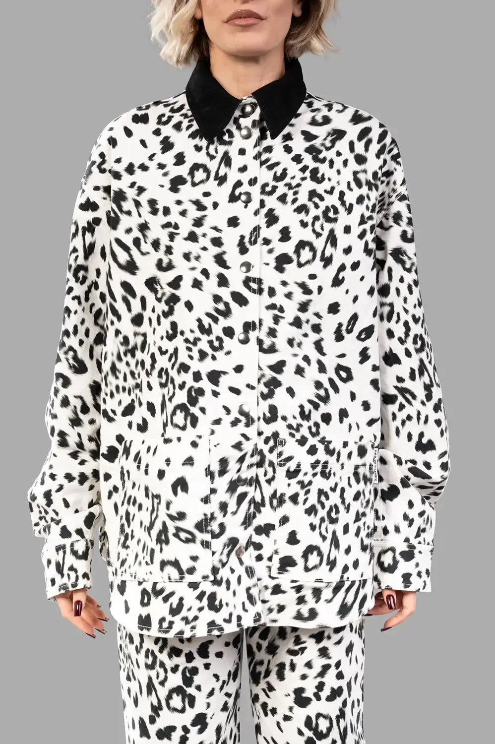 Front close-up showing snap front, black corduroy collar and large patch pockets in leopard print
