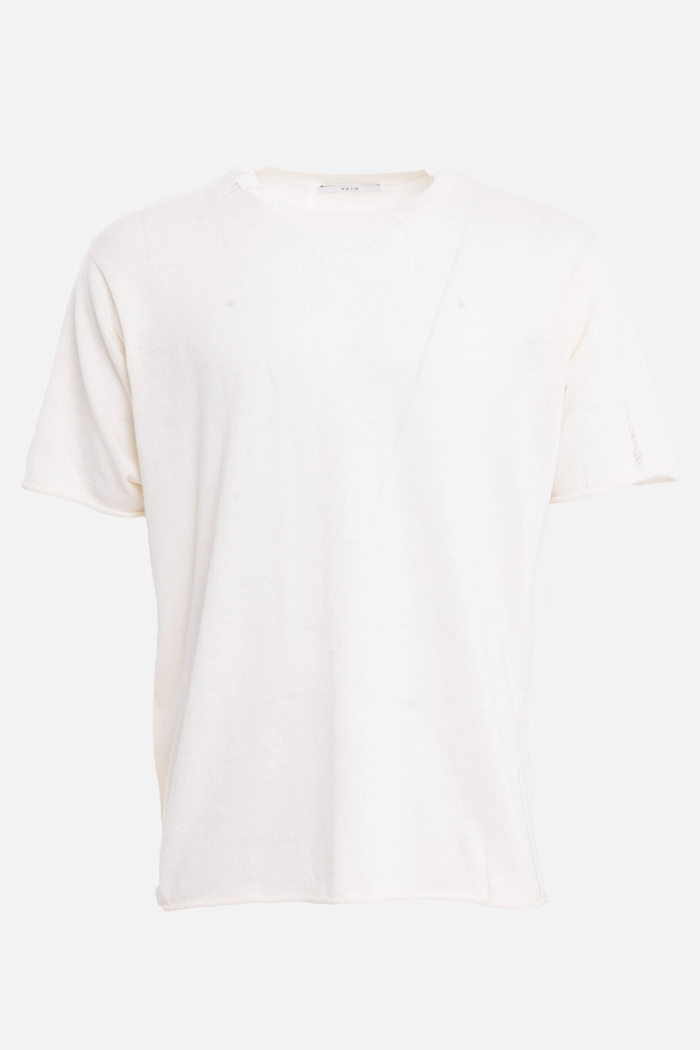 VEIN men's knit tee in cream, back view with rolled hem and distressed stitch detail