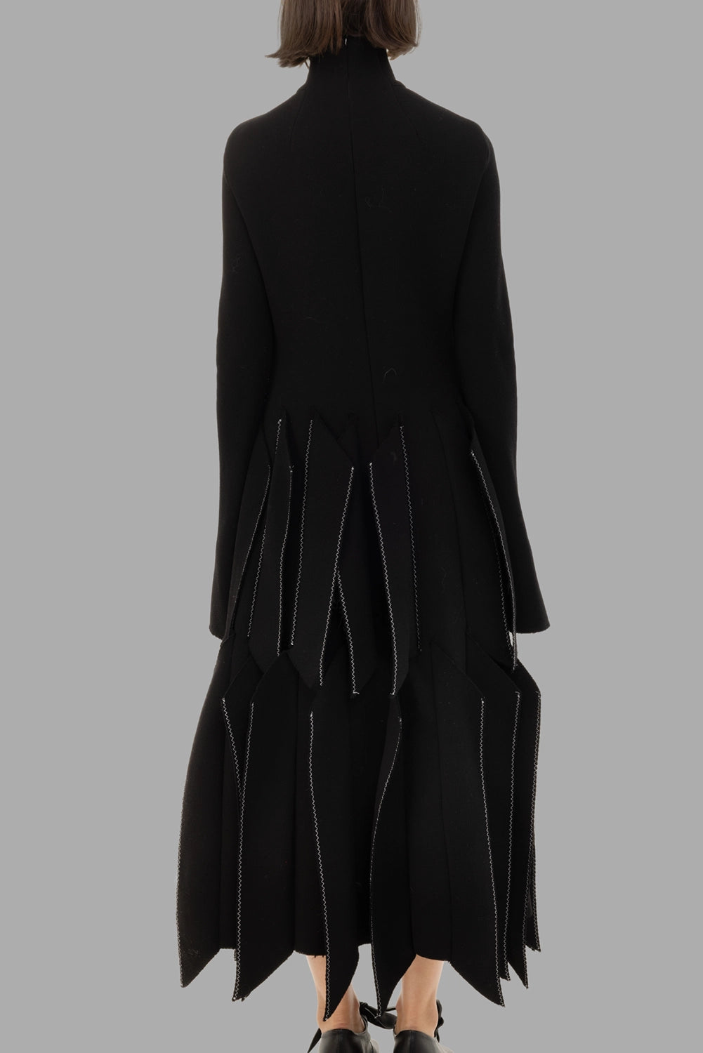 A.W.A.K.E. MODE women black dress, back view with contrast topstitch and layered skirt panels.