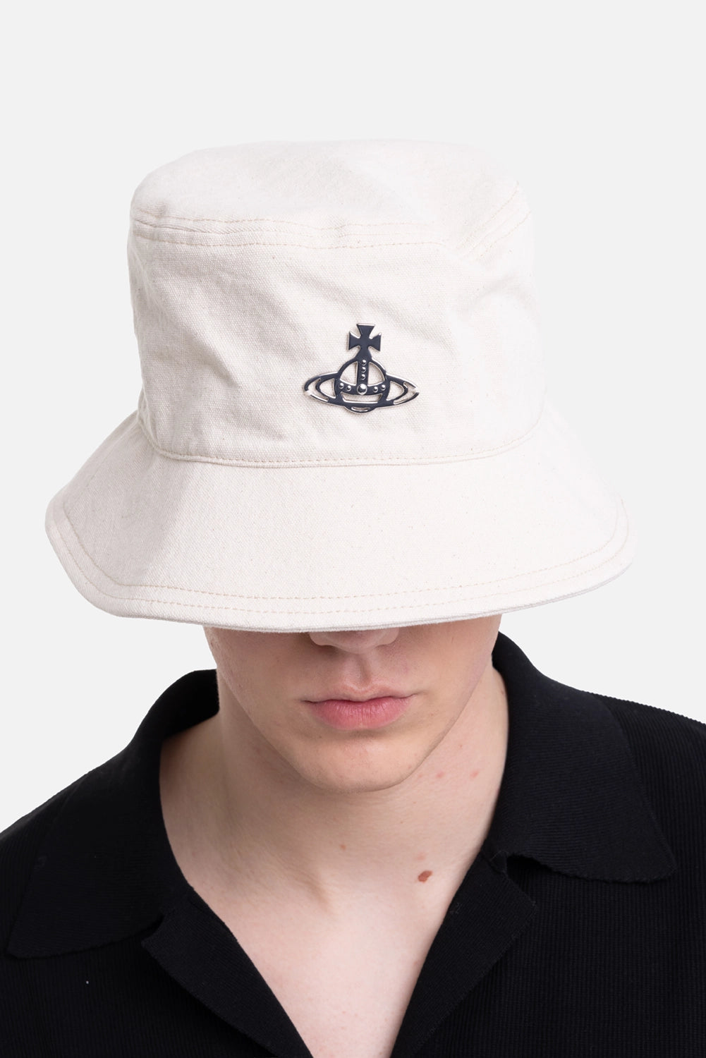 Vivienne Westwood unisex bucket hat in natural, on-model half-length view, silver-tone orb plaque