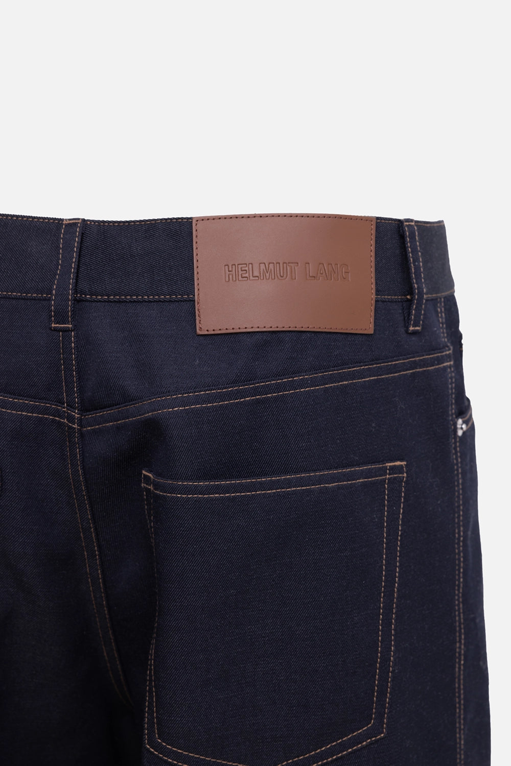 Helmut Lang men's five-pocket trouser in navy melange, logo detail view, leather logo patch and contrast stitching