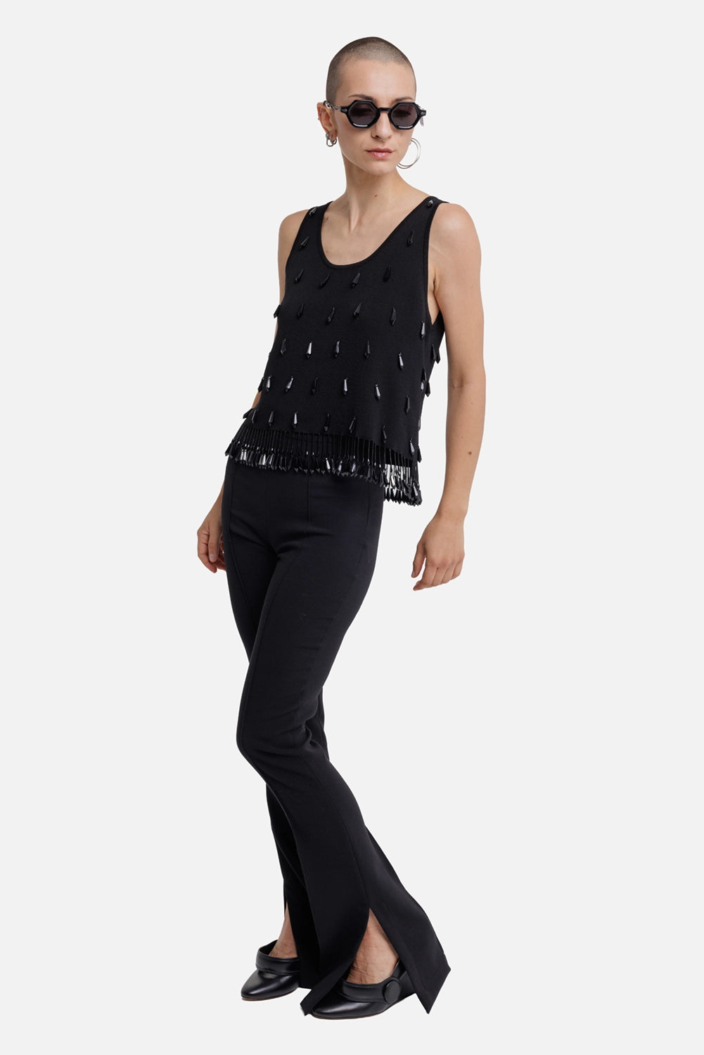 Des Phemmes women's black flared trousers, full-length model view with slim fit and split hems
