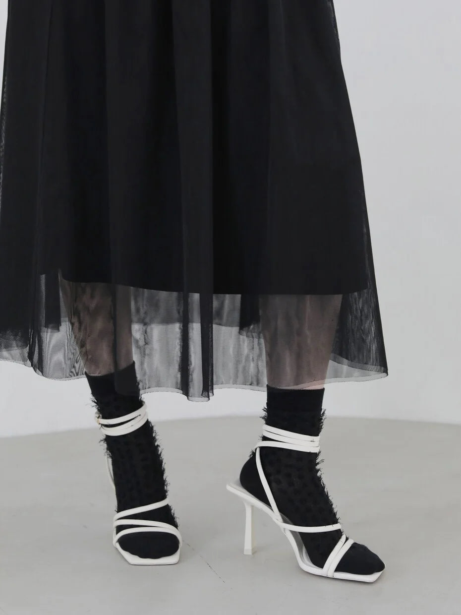Tabio. Fringe Style Low Crew Socks worn with a sheer black skirt, showcasing a unique glitter knit texture.