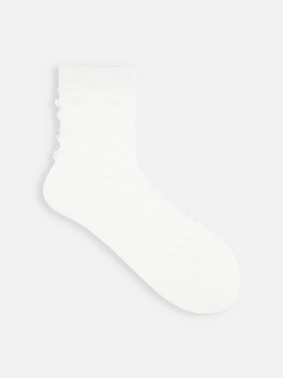 Tabio Fringe Style Low Crew Socks close-up, tousled texture in monochrome white, glitter knit fabric.