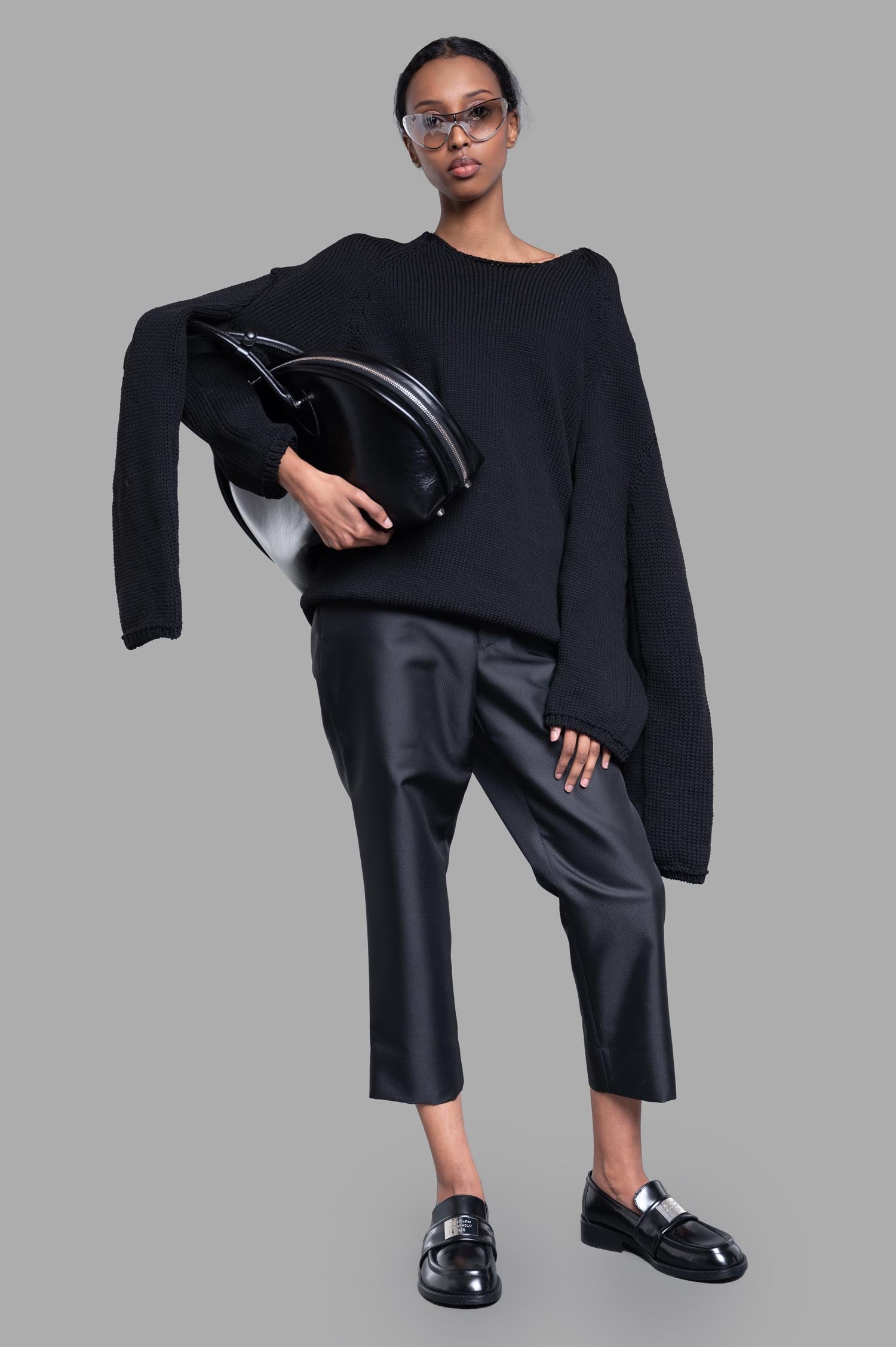 Comme des Garçons Multi-sleeve Sweater in black on model, showcasing unique extra sleeves and round neck design.