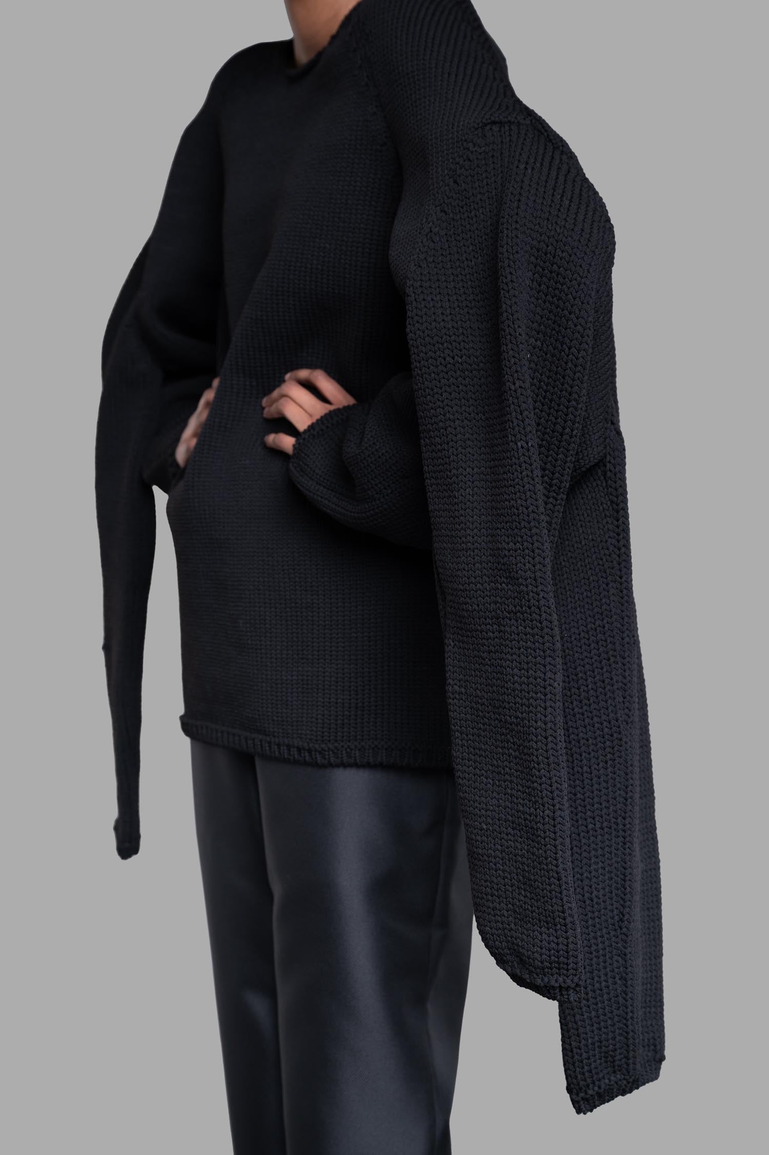 Comme des Garçons Multi-sleeve Sweater in black features unique extra sleeves, styled front view on model, textured knit.