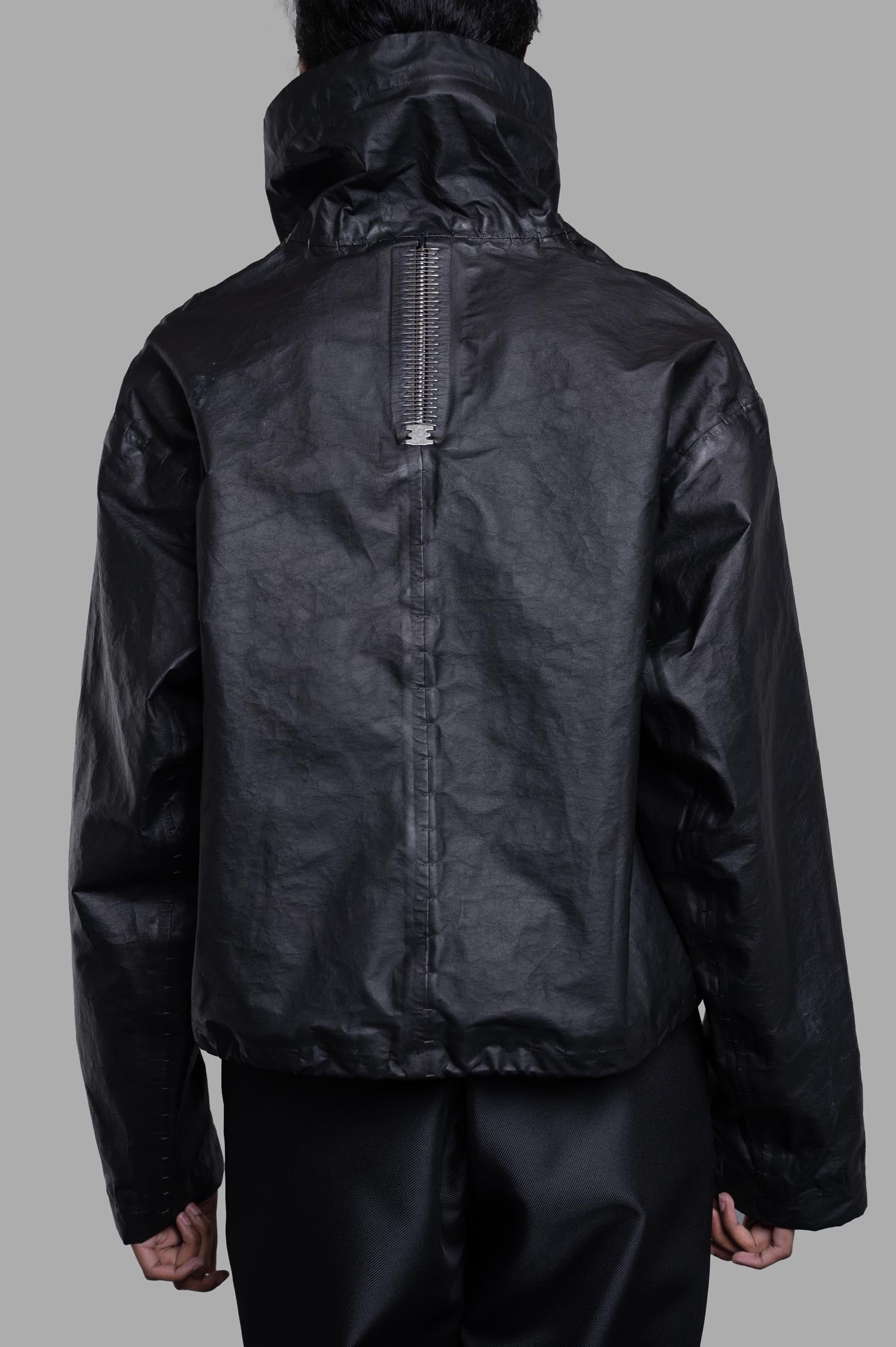 Isaac Sellam Cropped Windbreaker Jacket shown from the back, featuring tube neckline, zipper, and unique spine detailing.