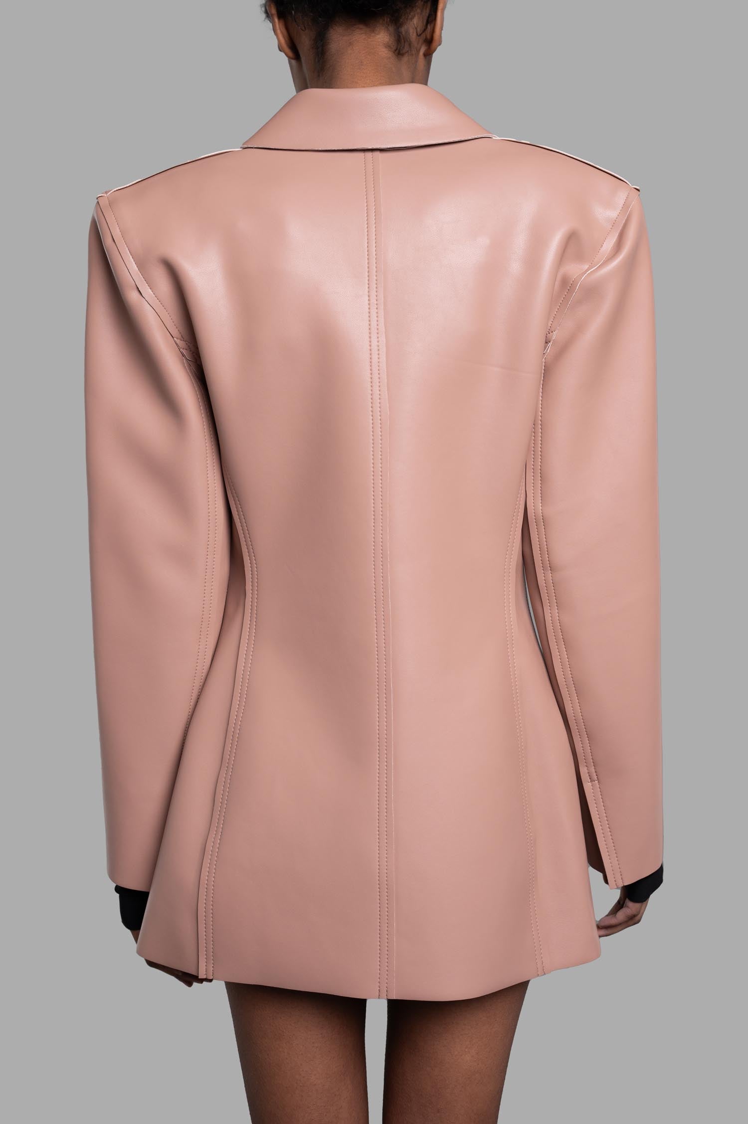 Norma Kamali Faux Leather Blazer in powder pink, showcasing the back design and luxurious texture for a chic look.