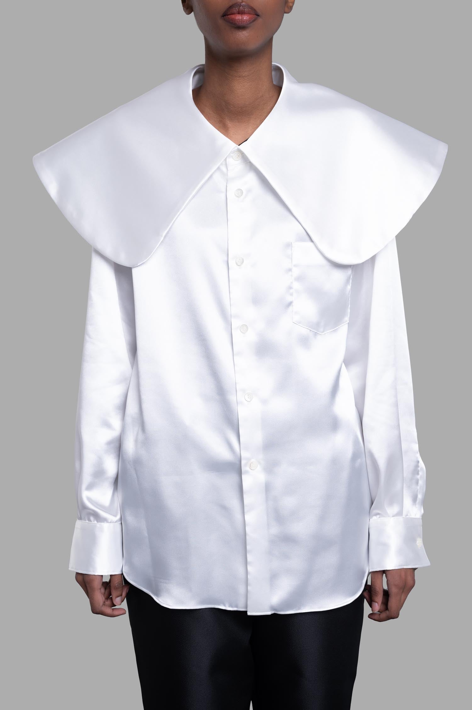 Comme des Garçons Oversized-collar Shirt in sleek white satin, featuring bold buttons, patch pocket, and stylish cuffs.