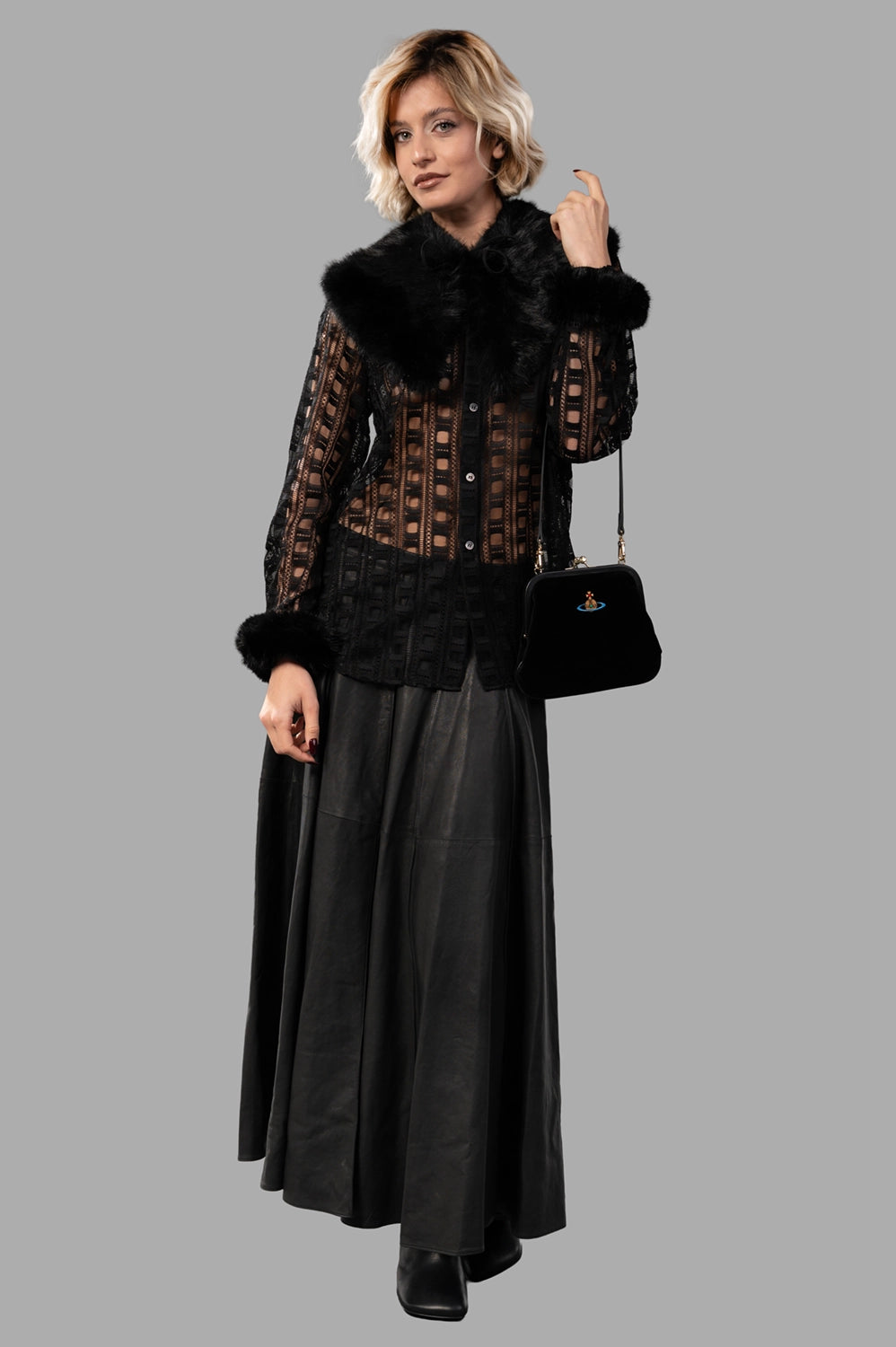 Full-length view of black leather maxi skirt with high waist, paneled construction and soft flare