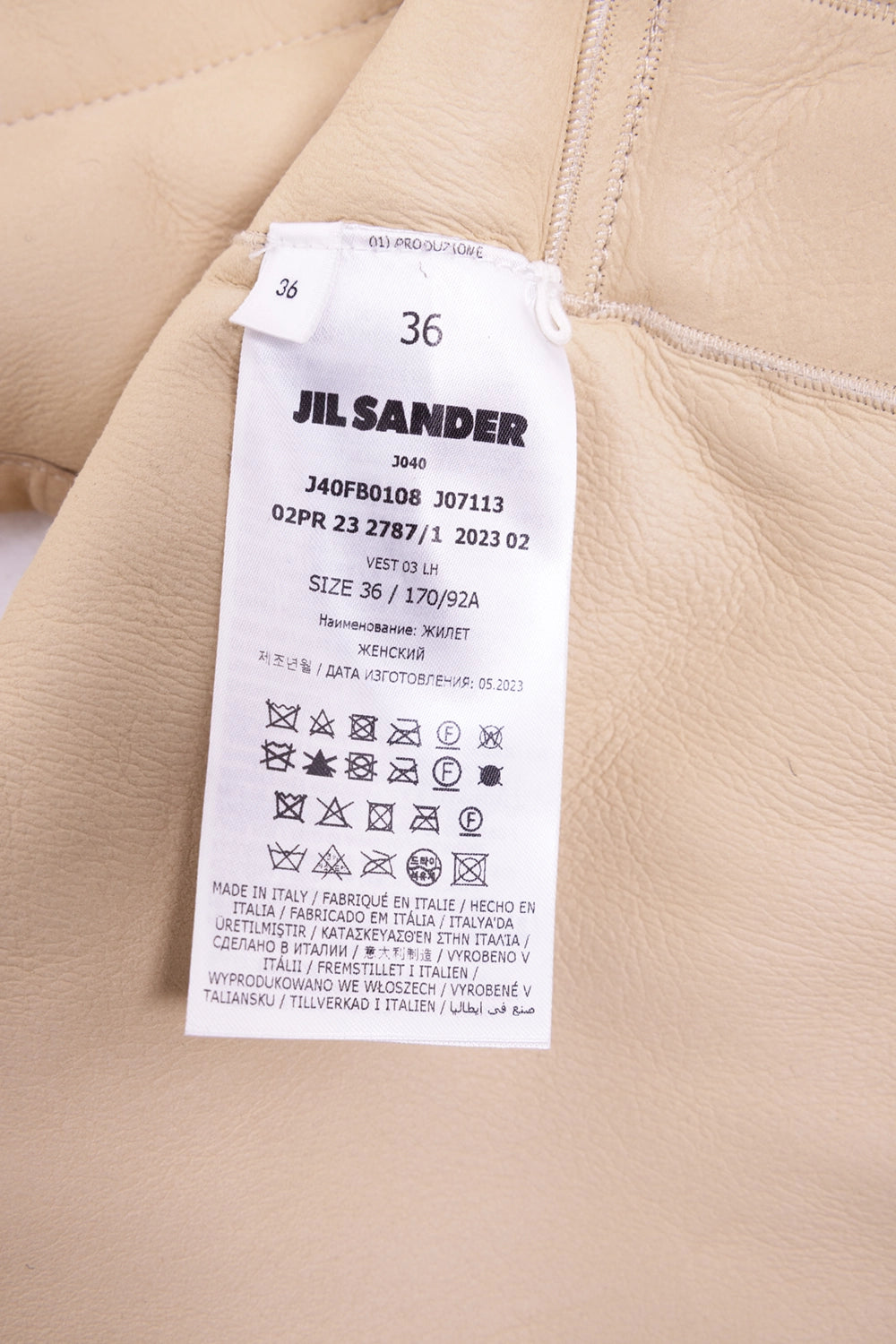 Pre-owned Jil Sander women's shearling gilet in sand beige, care-tag view, interior label showing size 36