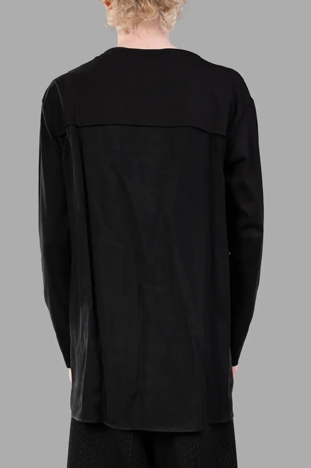 Back close-up of extended woven yoke panel and clean longline hem