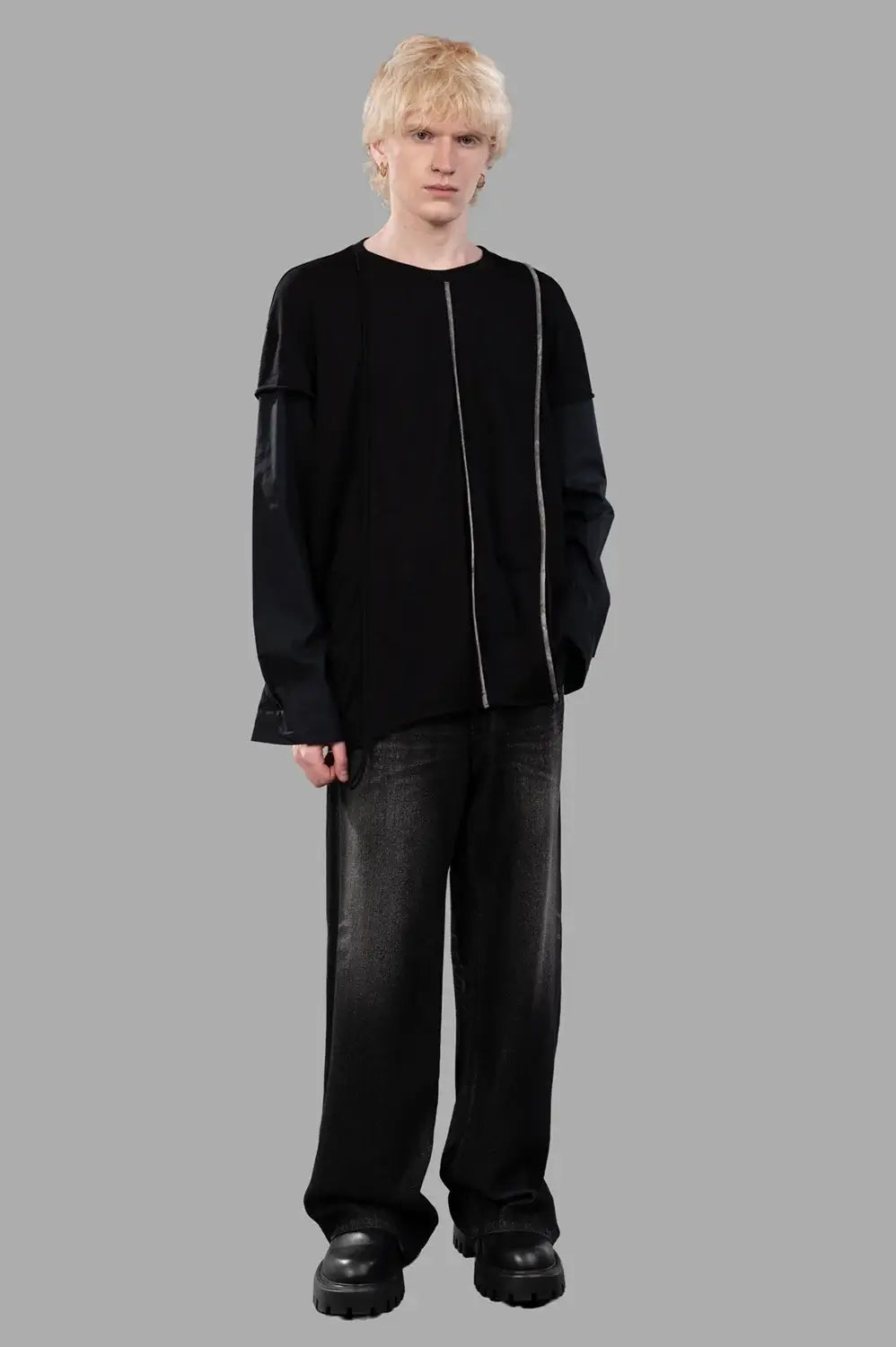 Full-length view of black long-sleeve tee with layered sleeves and contrast vertical trim; relaxed fit silhouette