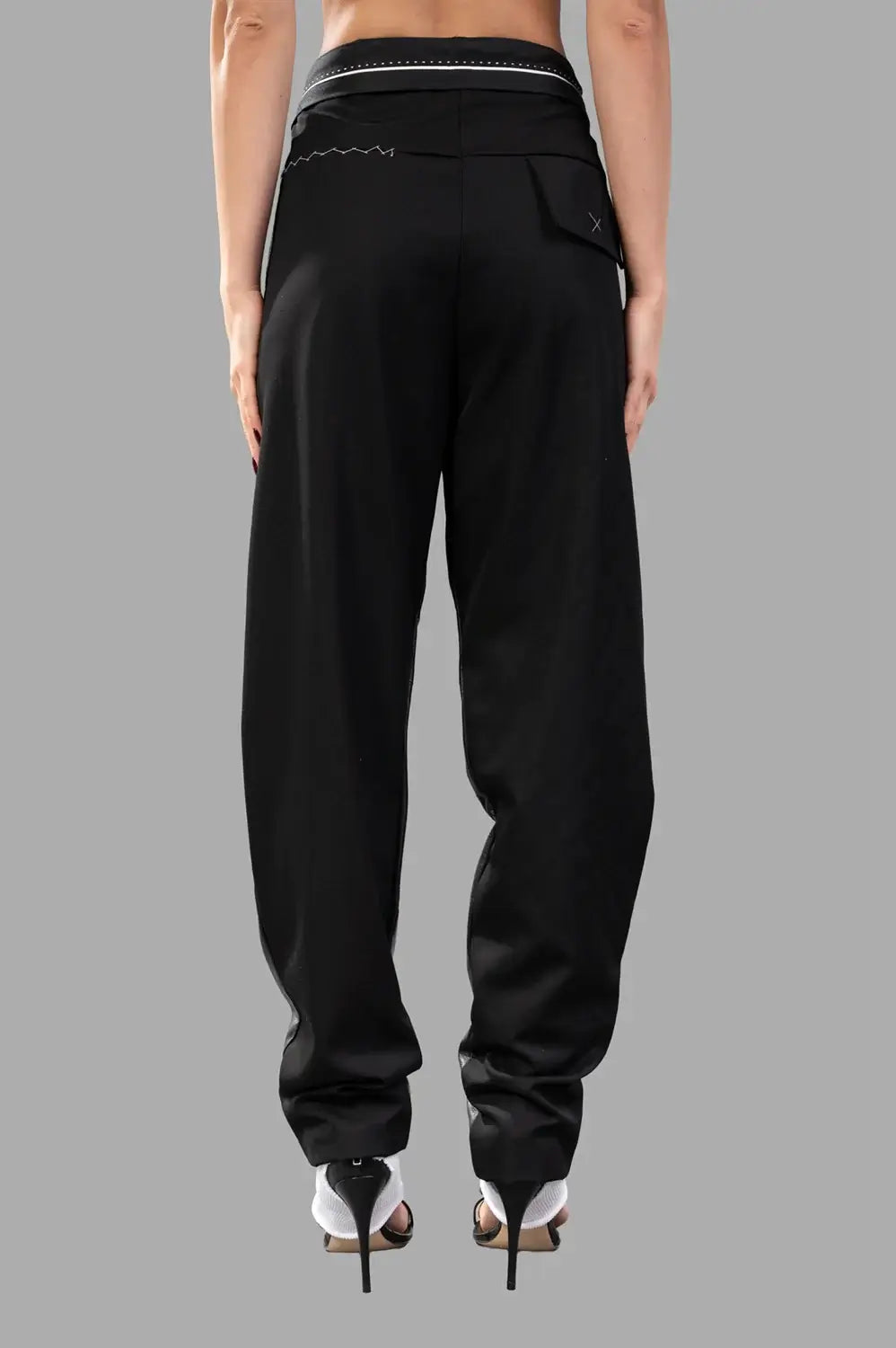 Back view close-up with matte fabric, contrast stitching at yoke and draped leg