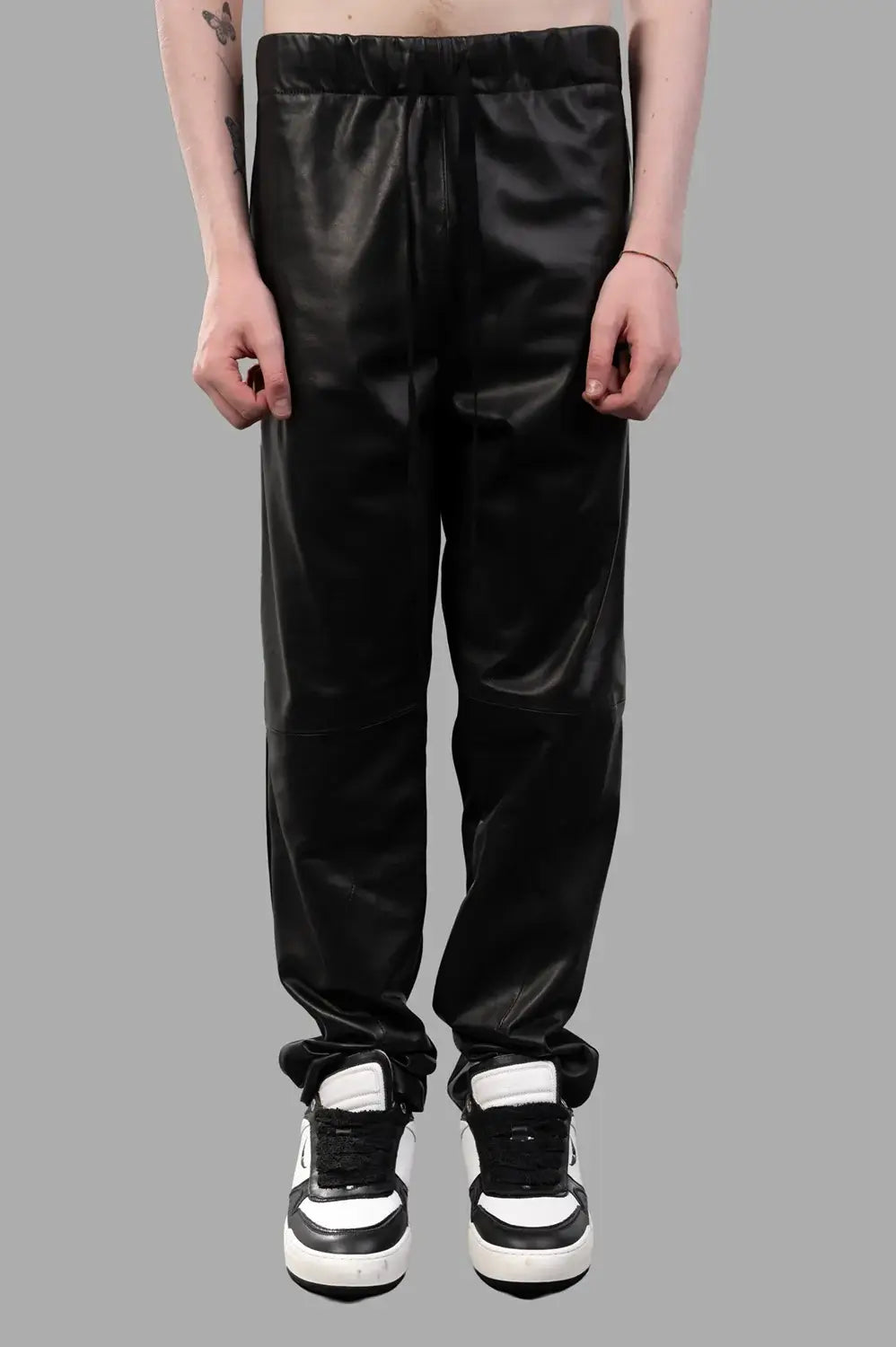 Front close-up of drawstring waist, smooth front panels and knee seam detail