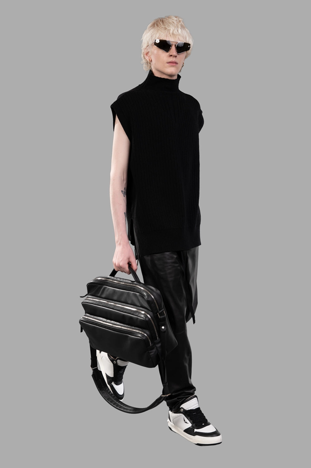 Full-length view of black drawstring pants with glossy front panels and relaxed straight leg