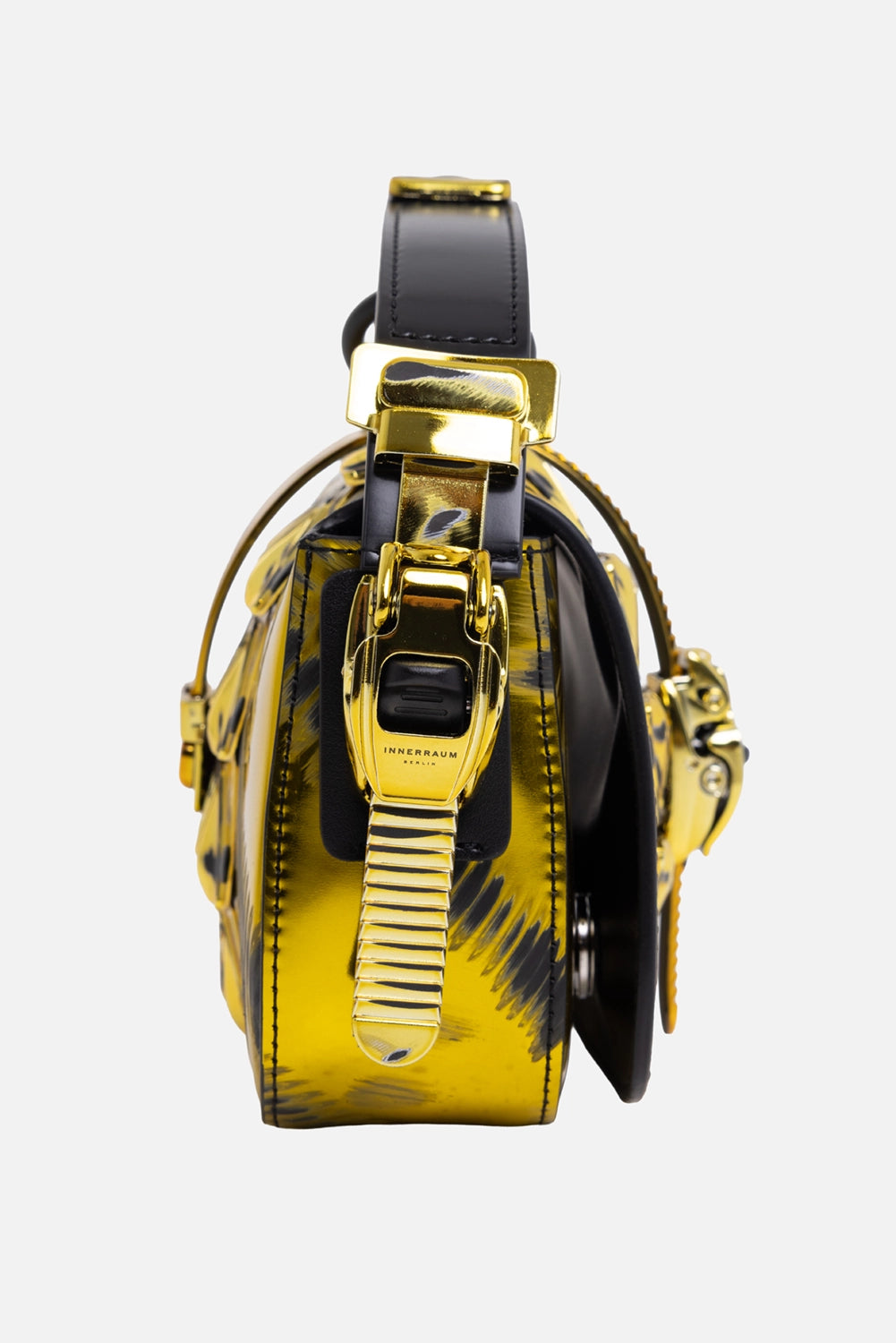 Innerraum women's handbag in acid gold, side view with polished side clasp and black matte ring handle