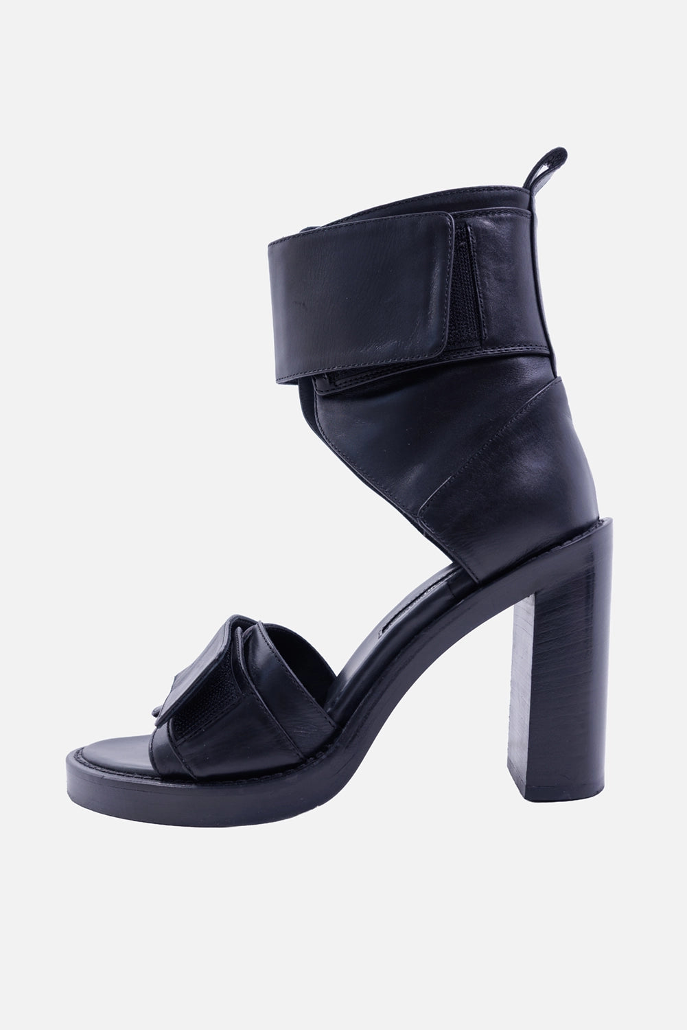 Ann Demeulemeester women's black leather sandals, rear 3/4 view with pull tabs, ankle cuffs and block heels