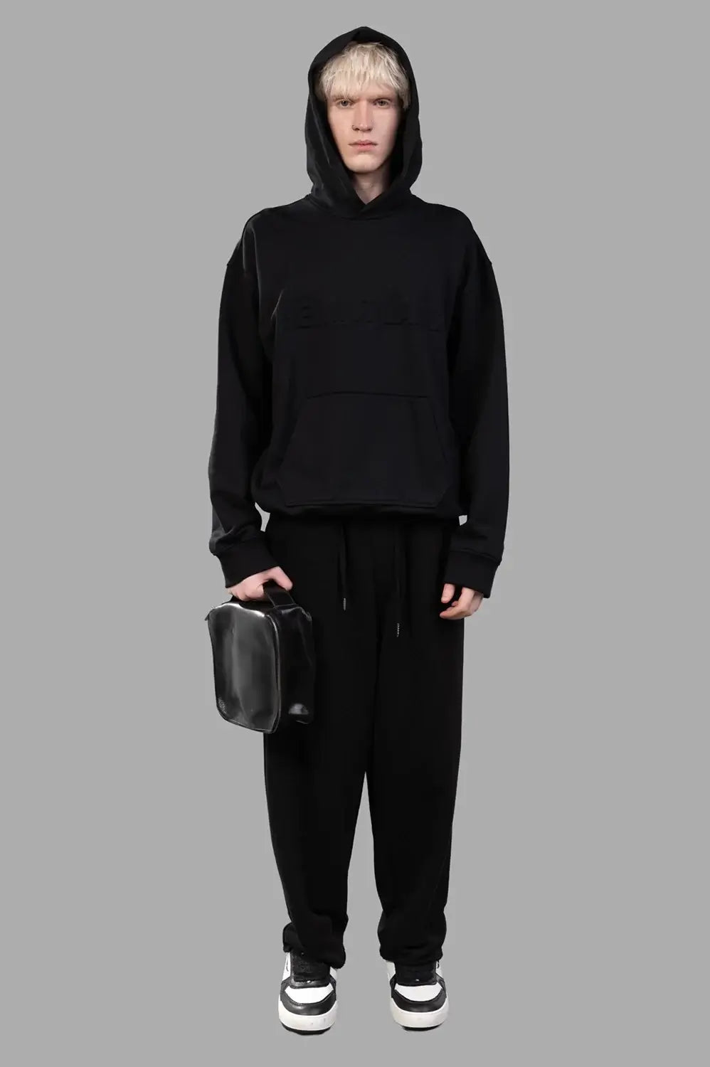 Full-length black hoodie with embossed front logo, kangaroo pocket and ribbed trims