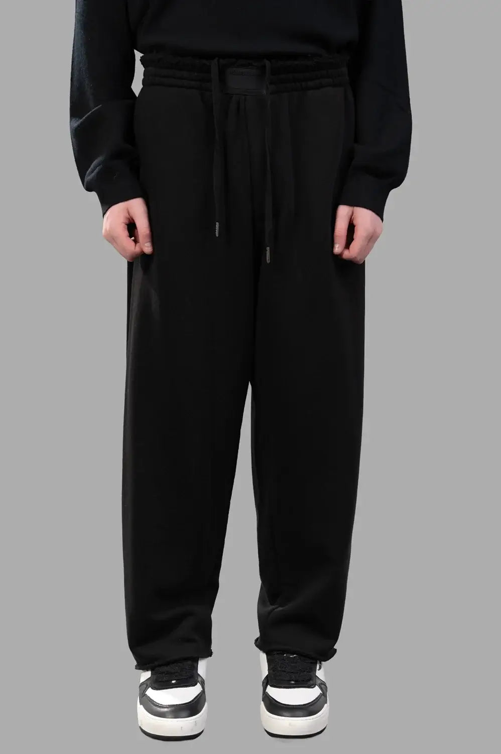 Back view of sweatpants with patch pockets and relaxed drape