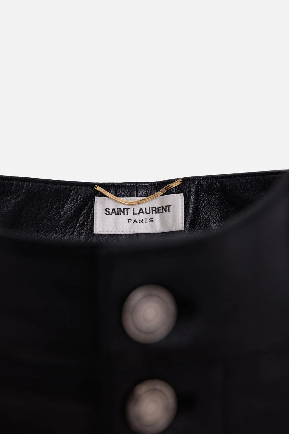 Saint Laurent women's leather shorts in black, label detail with white tag, gold loop and button fly