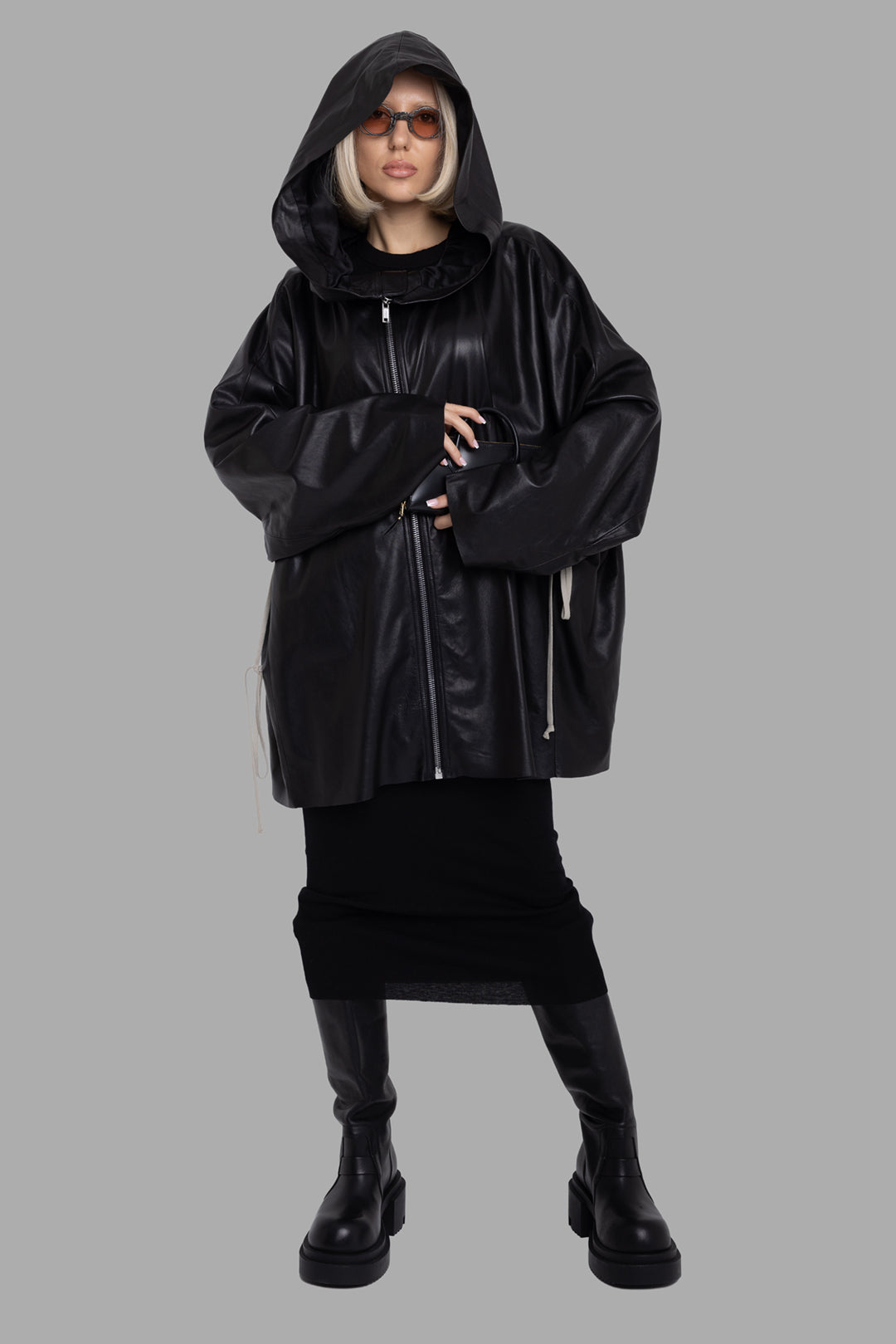 Rick Owens women's black hooded leather jacket, full-length on-model view with oversized hood and elongated side drawstrings.