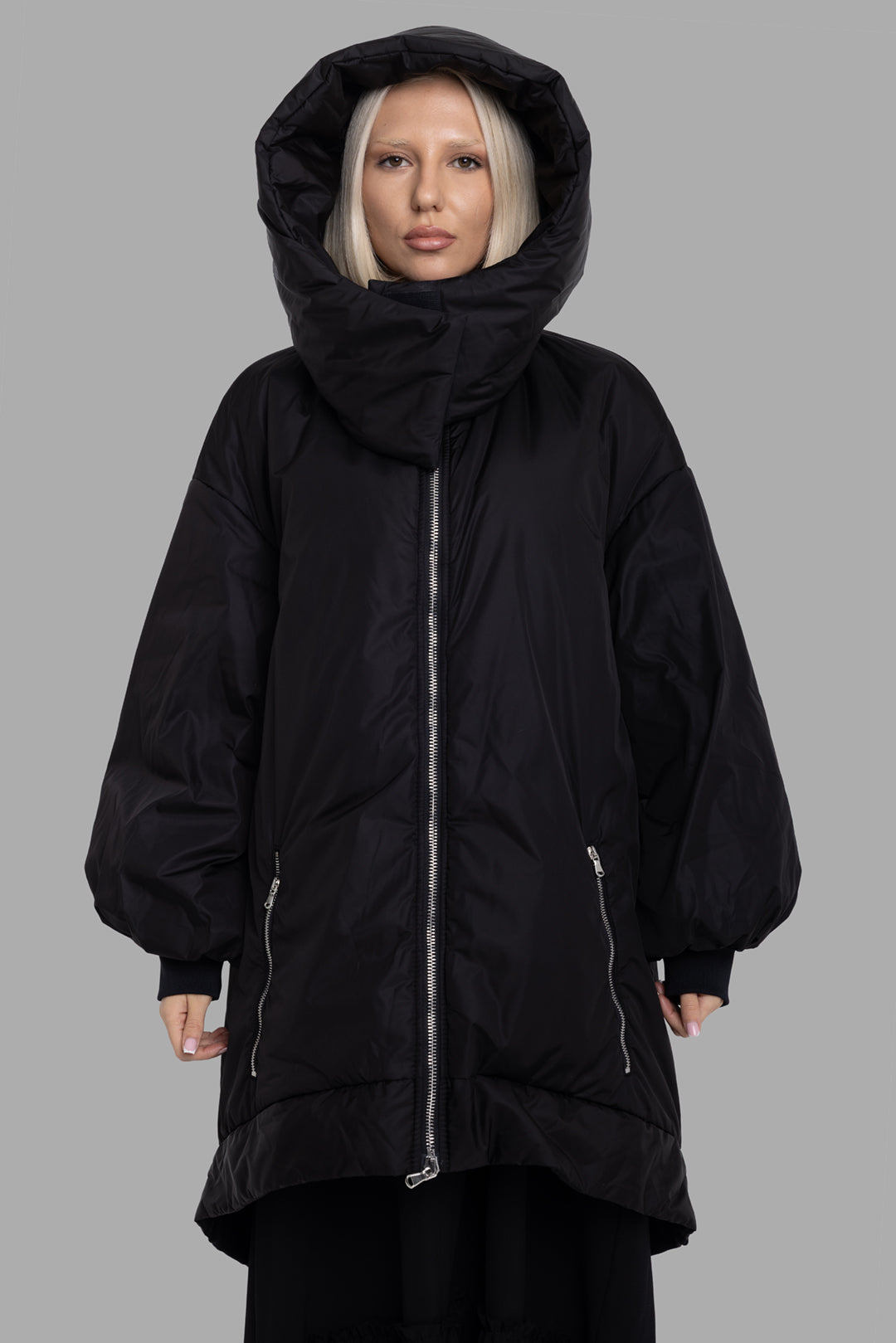 Sehnsucht Atelier women's black hooded puffer coat, front view, sculpted funnel hood with two-way metal zip and zip pockets.