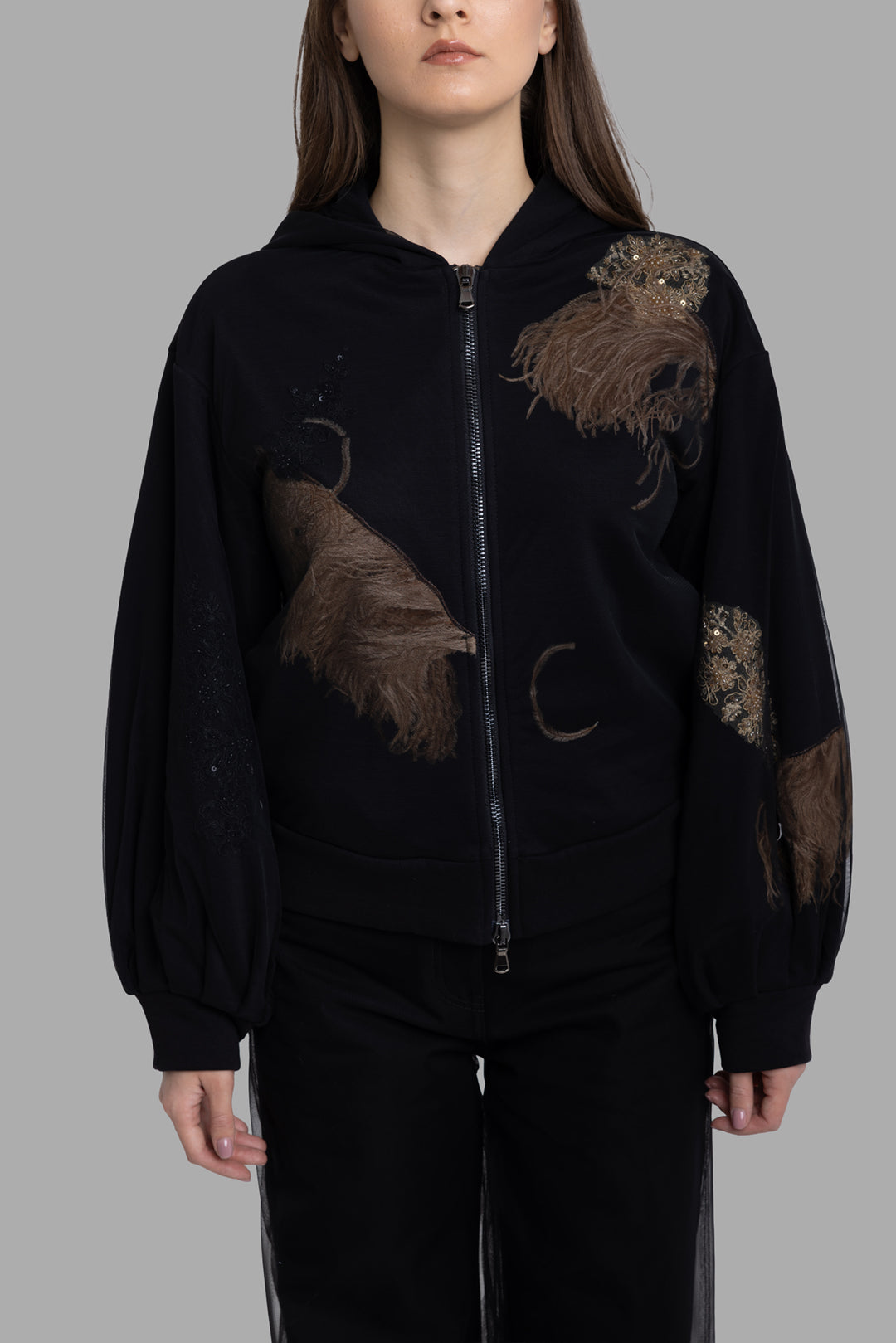 Sehnsucht women's hoodie in black, front view, sequinned motif and long-haired feather panels.