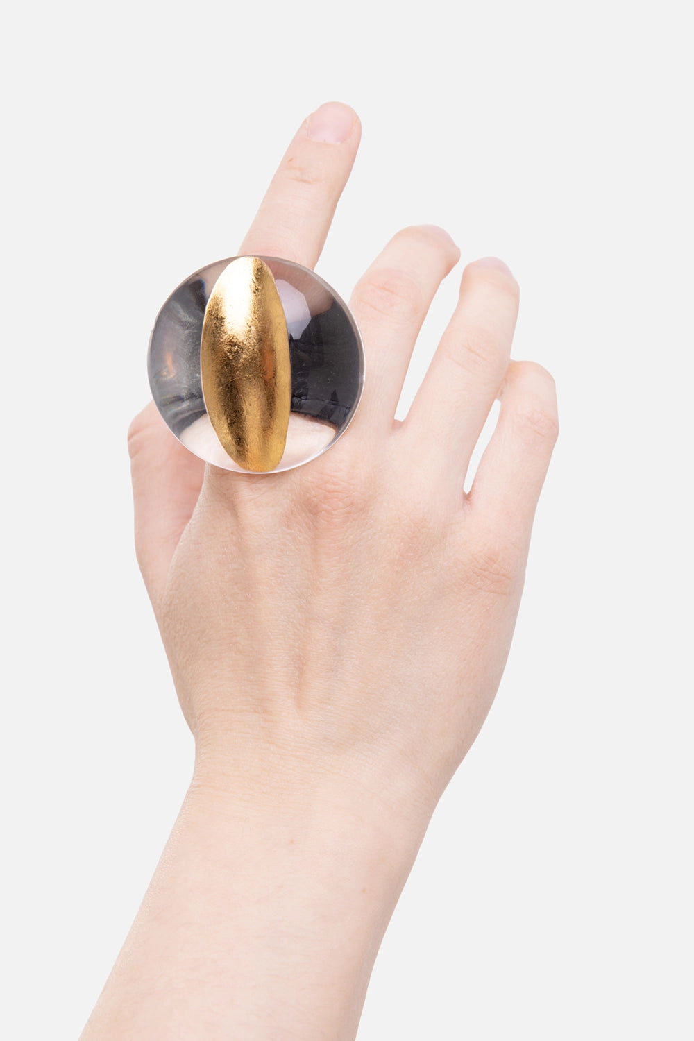 Monies Ibex acrylic ring in gold, on-hand view with clear disc and raised gold-foil crest