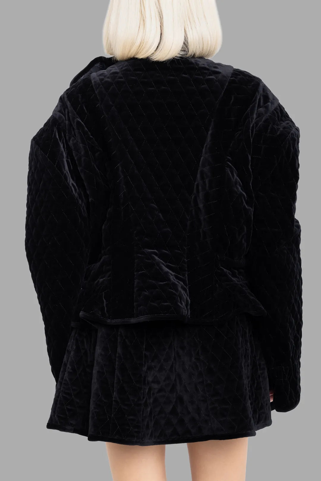 Vivienne Westwood women's black fencing jacket, back view, quilted cotton velvet with gentle peplum flare at hem.