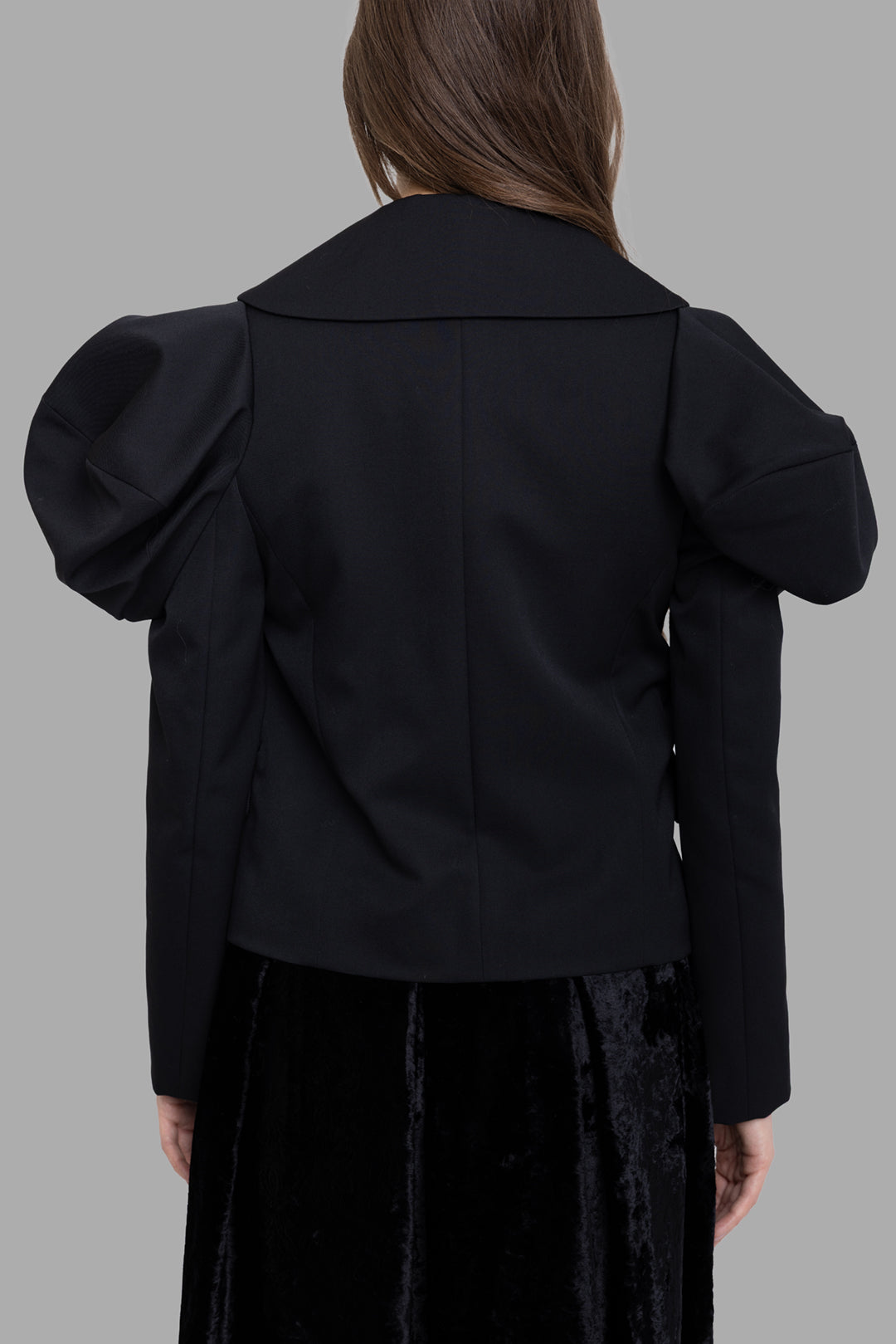 Comme des Garçons women's black wool puff-sleeve jacket, back view, sculpted shoulders and clean cropped hem.