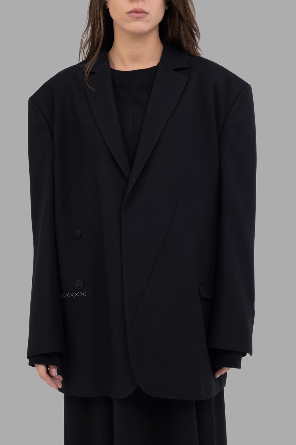 Giovanni Cavagna women’s blazer in black, front view, deep notch lapels and two-button wrap front