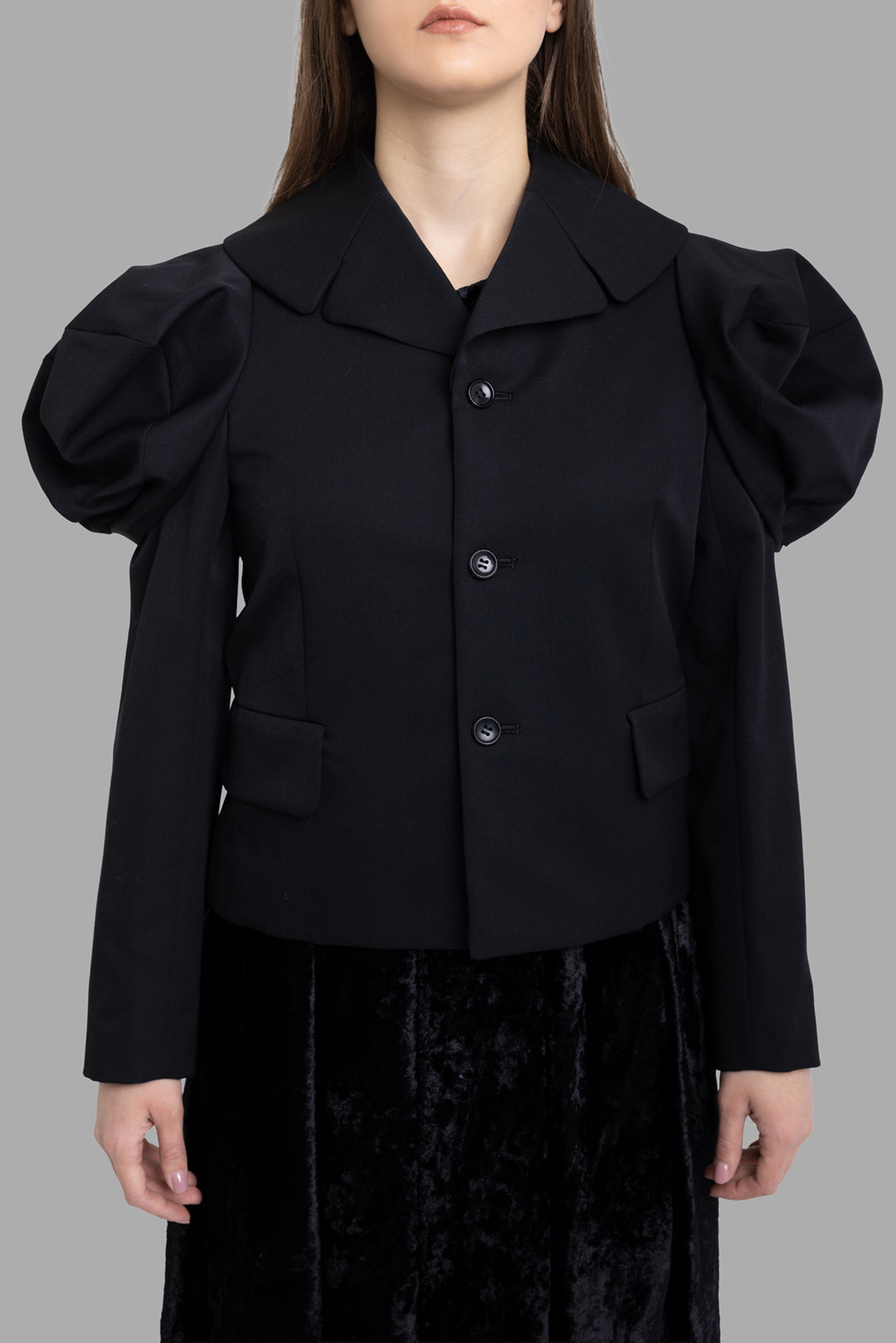 Comme des Garçons women's black wool puff-sleeve jacket, front view, wide collar and button closure with flap pockets.