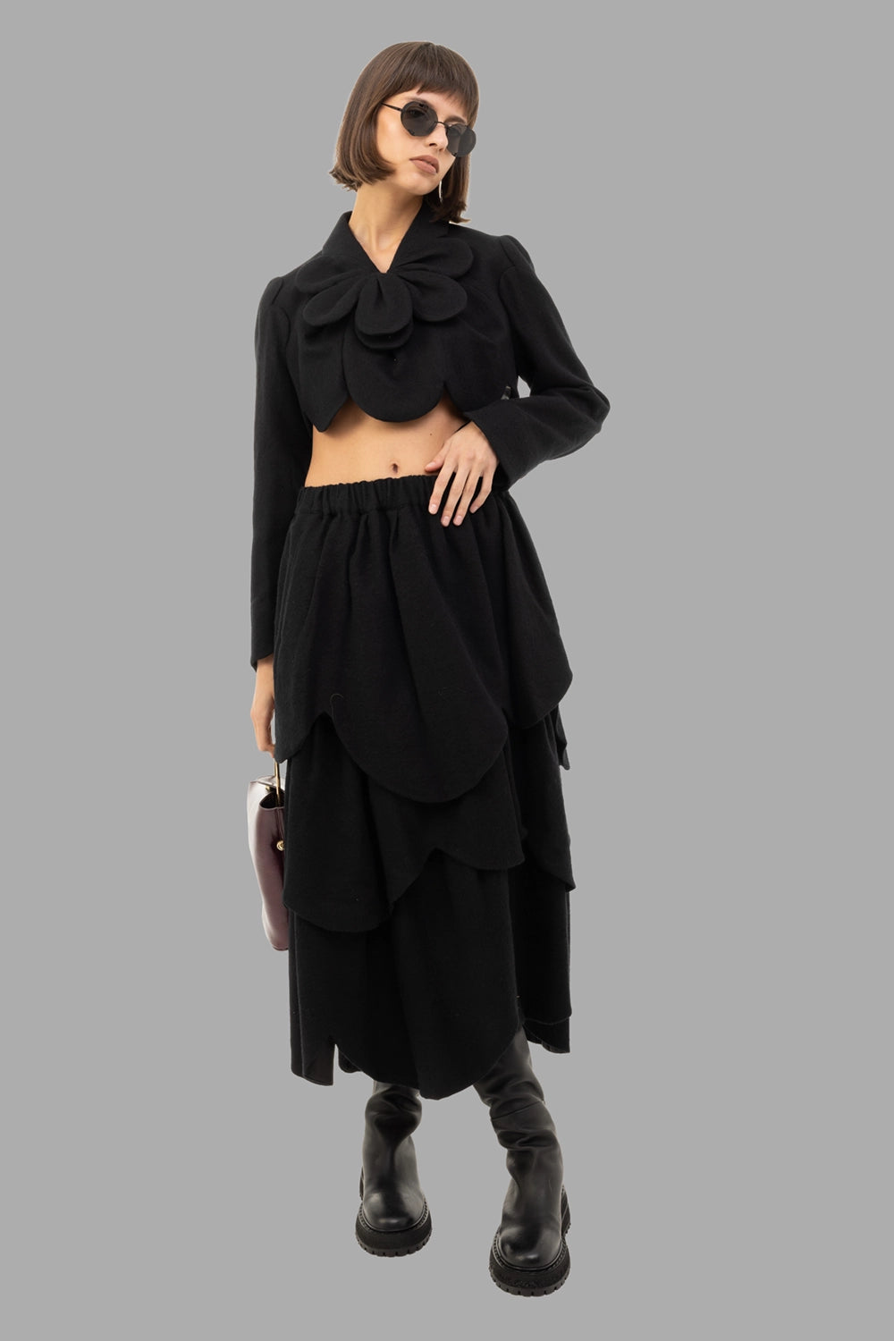 Noir Kei Ninomiya women’s cropped wool jacket in black, full length on model, petal collar and scalloped hem