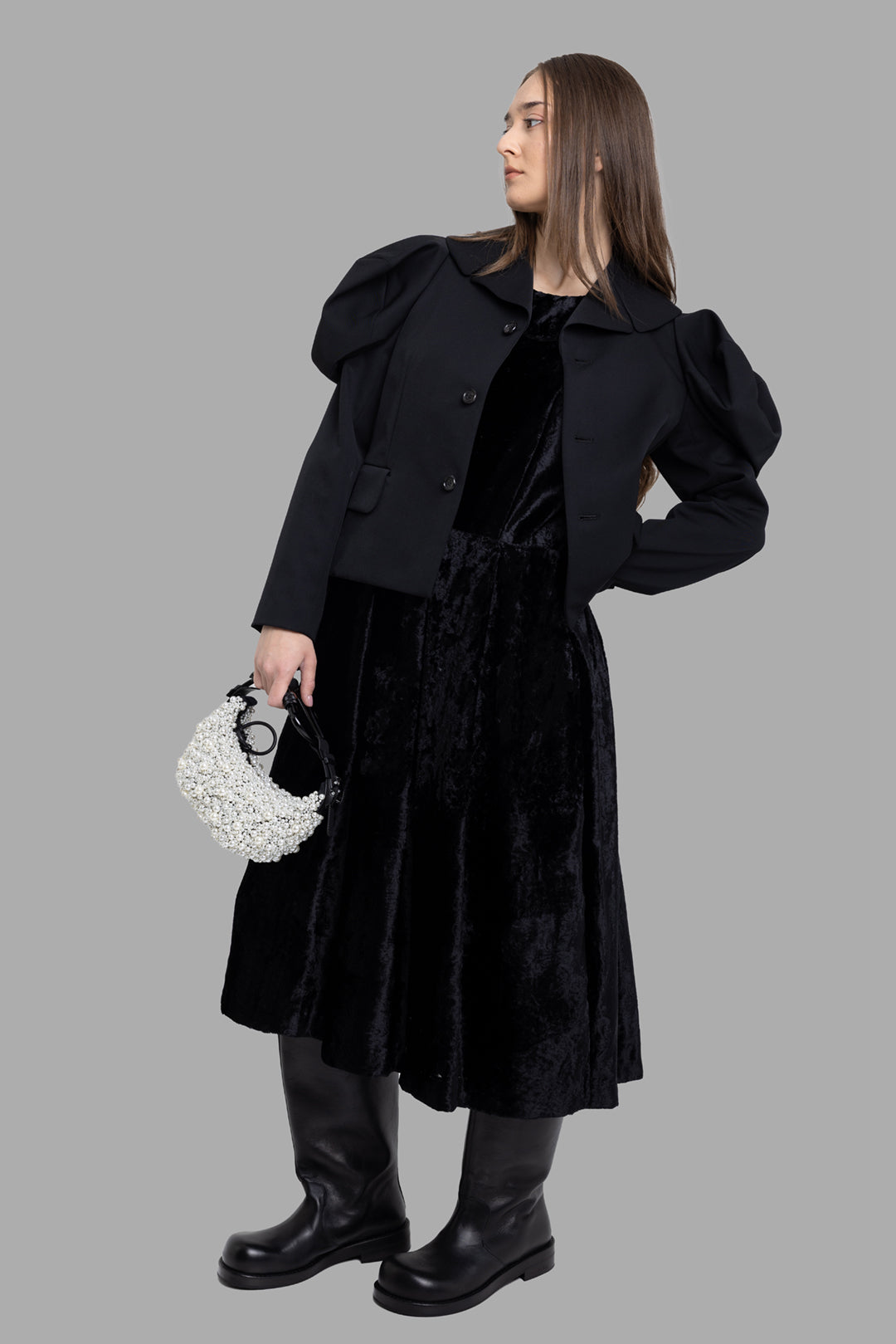 Comme des Garçons women's black wool puff-sleeve jacket, on-model full-length, cropped hem and flap pockets.