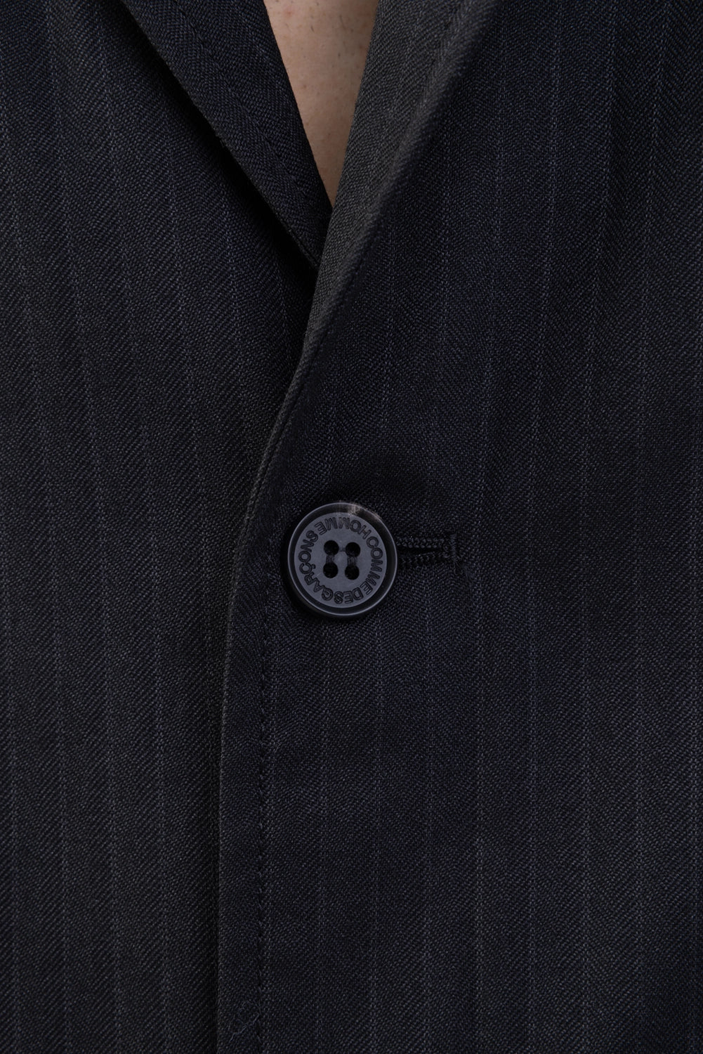 Junya Watanabe jacket in black pinstripe, close-up of logo button and fine pinstripes