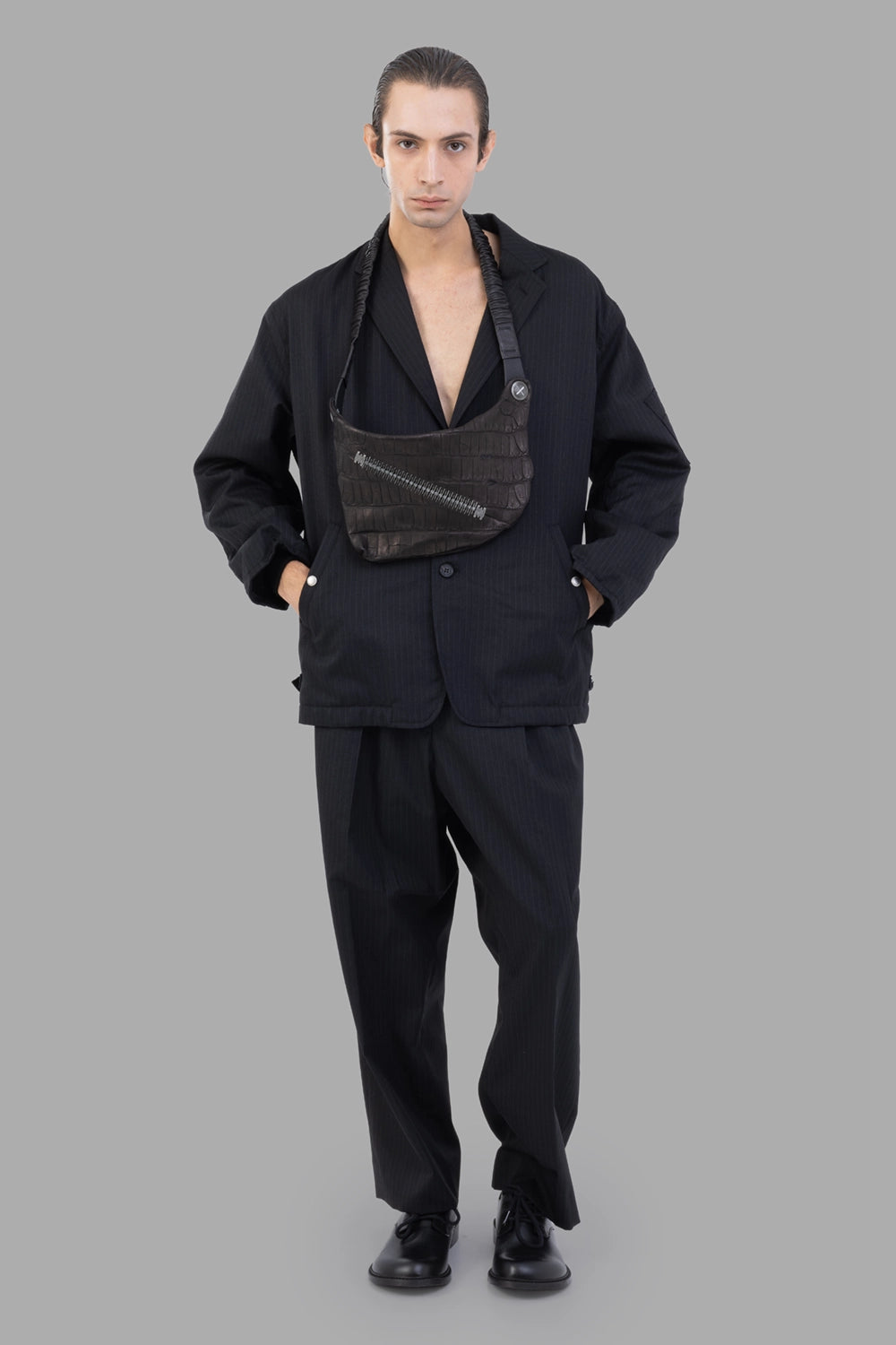 Junya Watanabe jacket in black pinstripe, full-length on model, relaxed fit with wide lapels