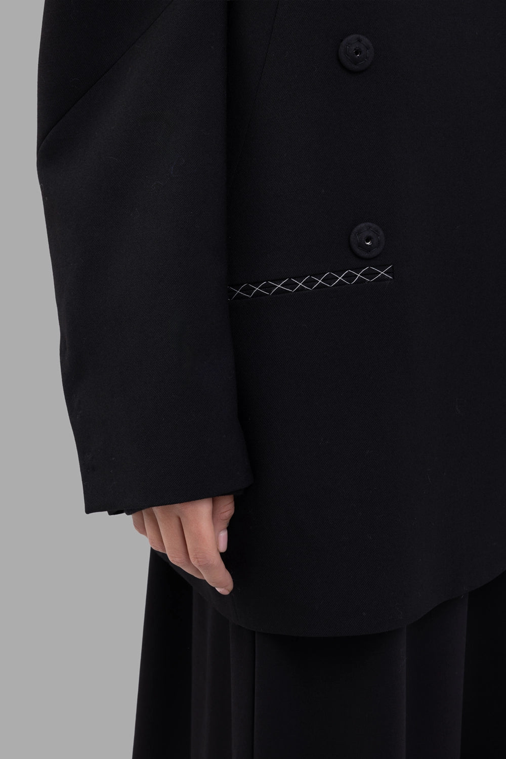 Giovanni Cavagna women’s blazer in black, pocket detail, white cross-stitch at welt pocket
