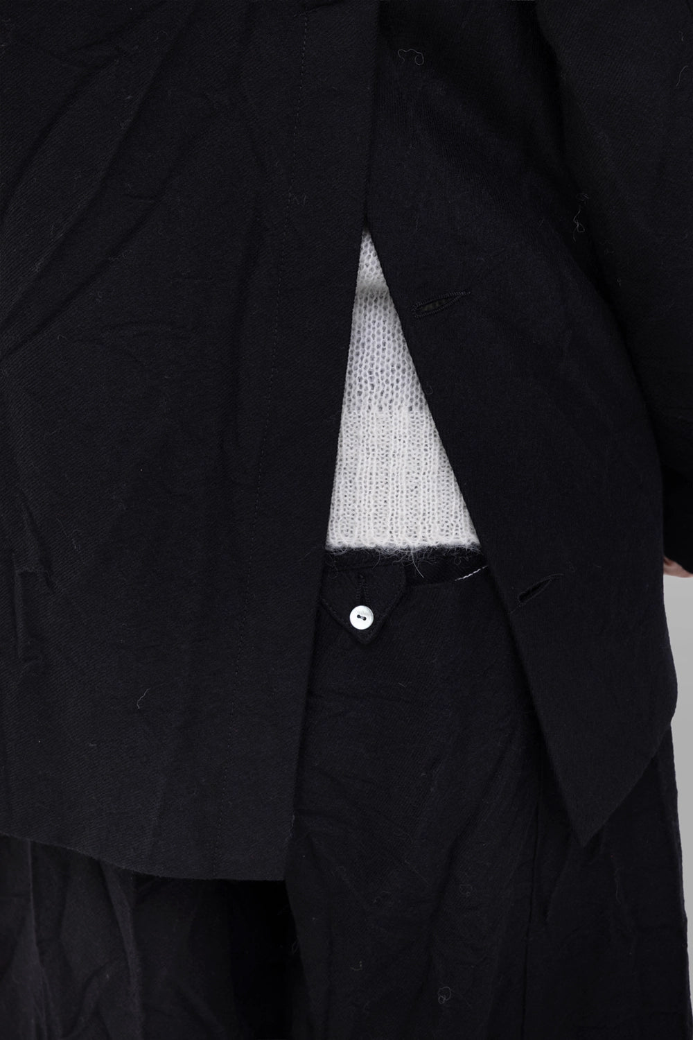 Marc Point women’s black jacket, vent detail showing long back slit and textured wool.