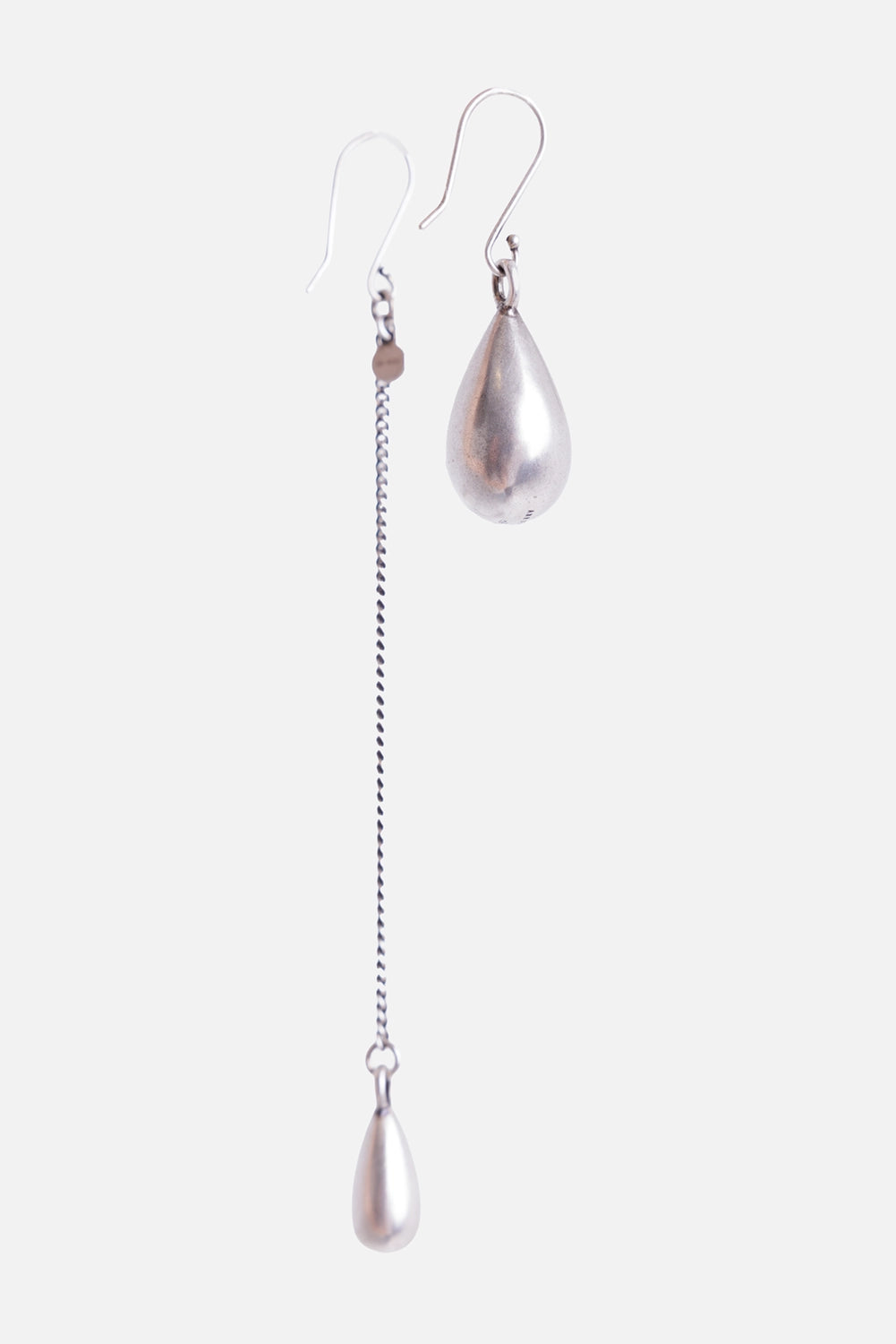 Ann Demeulemeester Judith earrings in antique silver, front view with asymmetric chain and teardrop pendants