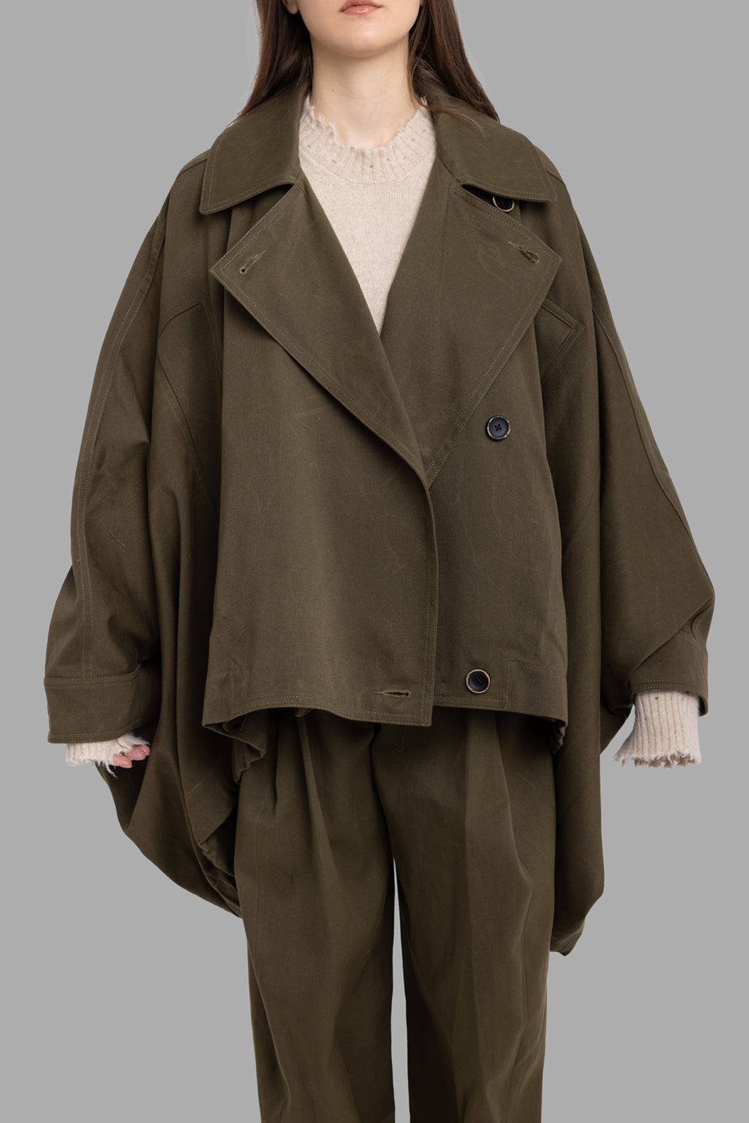Uma Wang women's dark green Kew jacket, on-model half-length front view showing large welt pockets and wide batwing sleeves