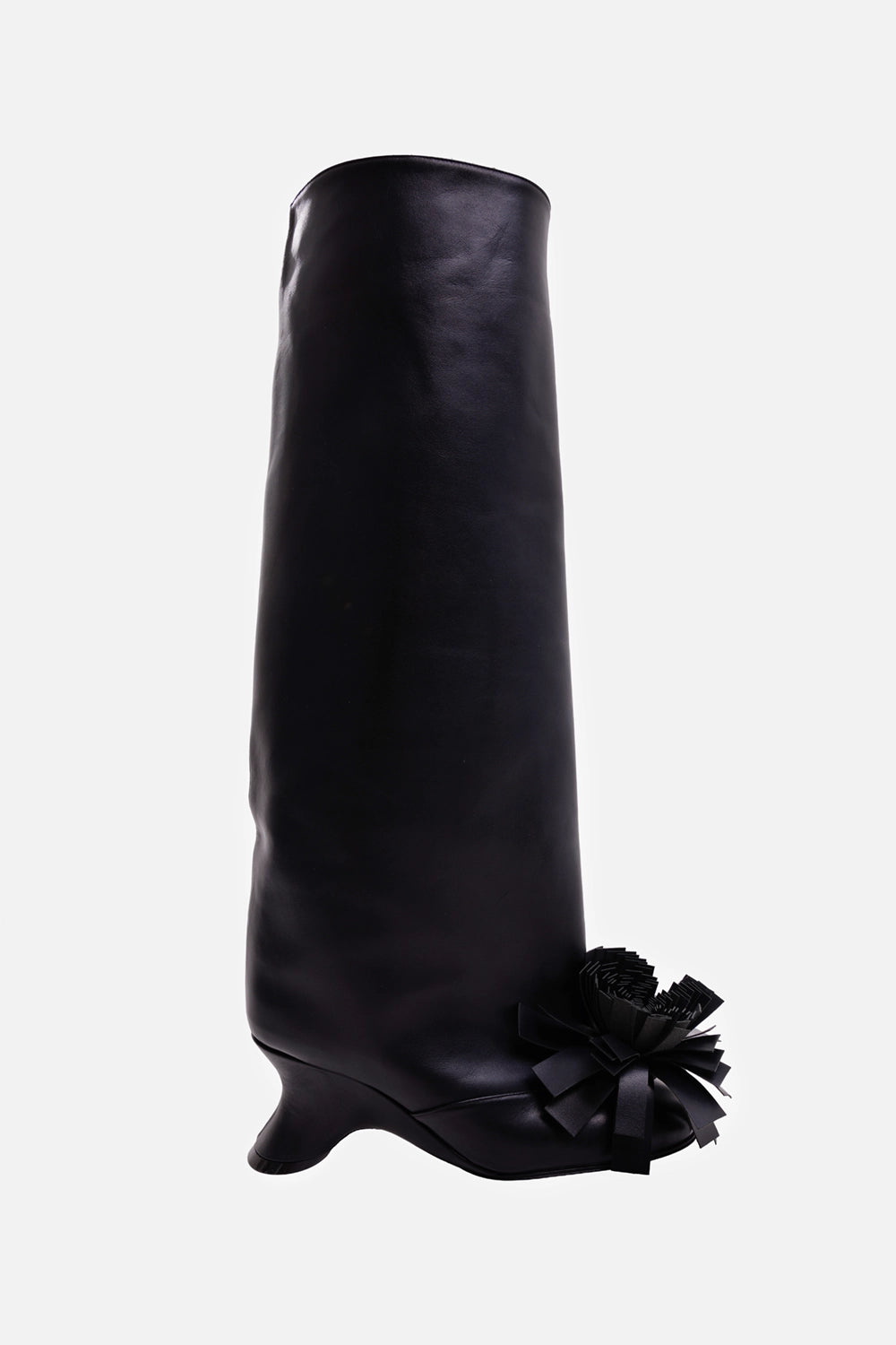 A.W.A.K.E. MODE women's black knee-high boot, side view with oversized pom-pom and sculptural wedge heel