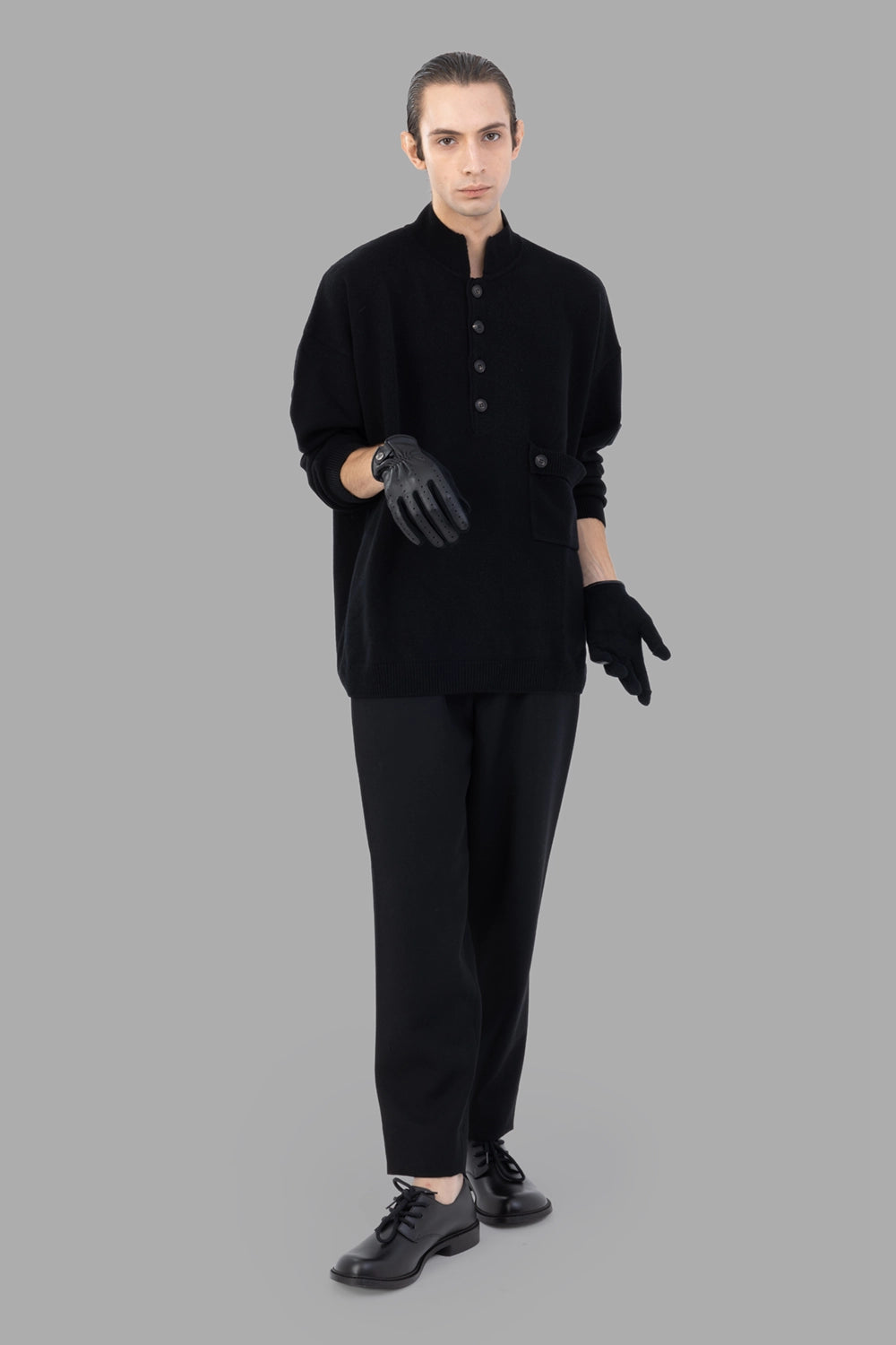 AION knit pullover in black, on-model full length, relaxed drop-shoulder fit
